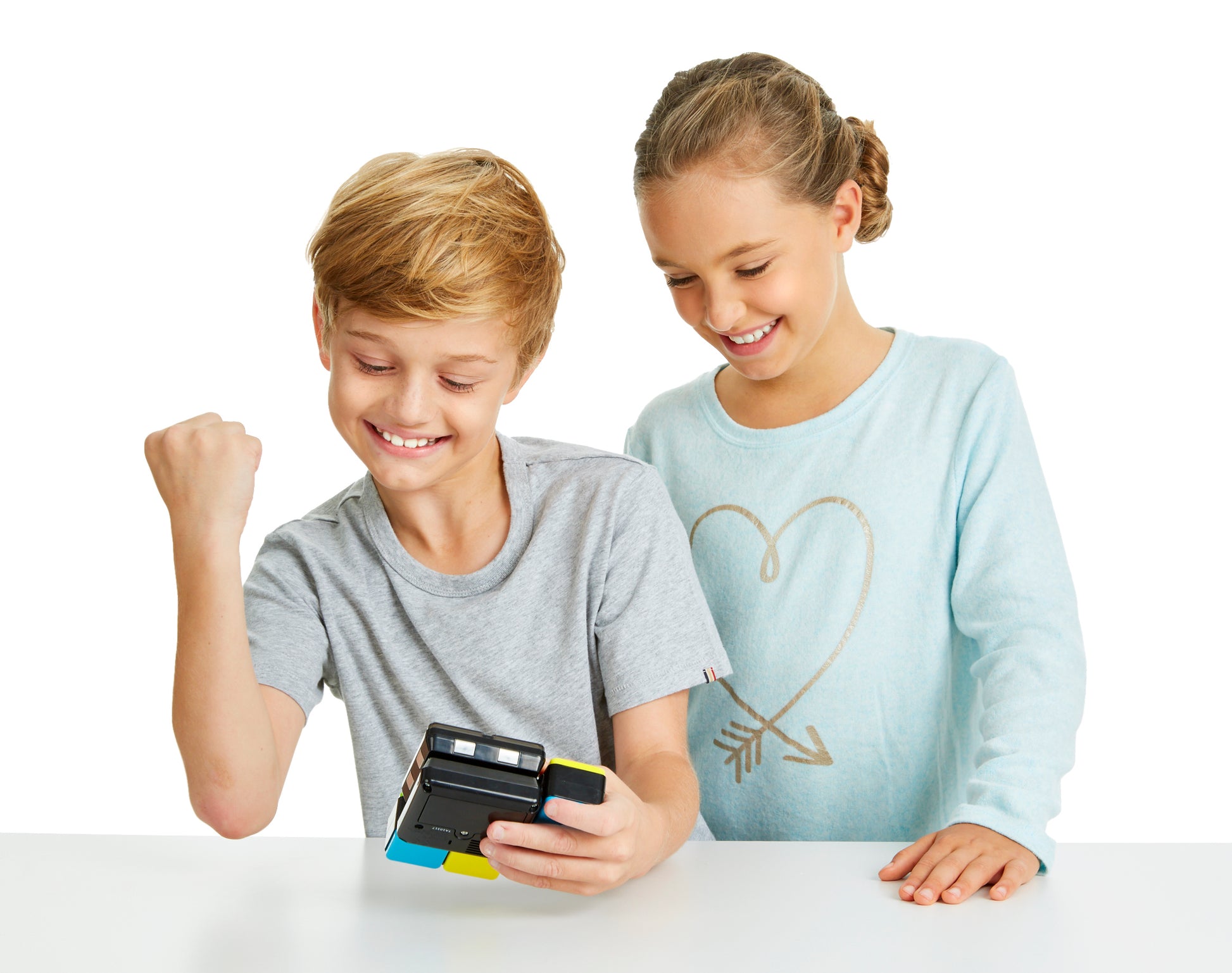 Two children playing with Flip Side game on a white background