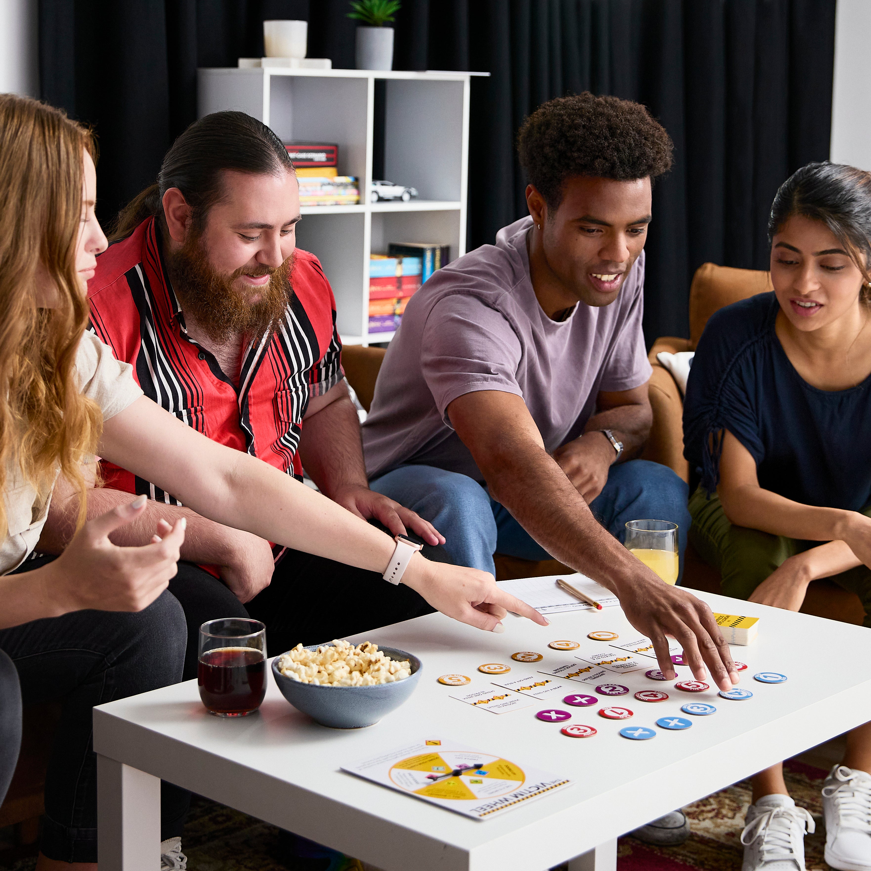 Group of friends playing a board game together in a cozy living room.