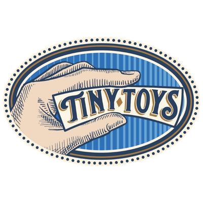 A vintage-style logo with a hand holding a card that reads Tiny Toys in decorative lettering on a blue striped oval background with dotted border.