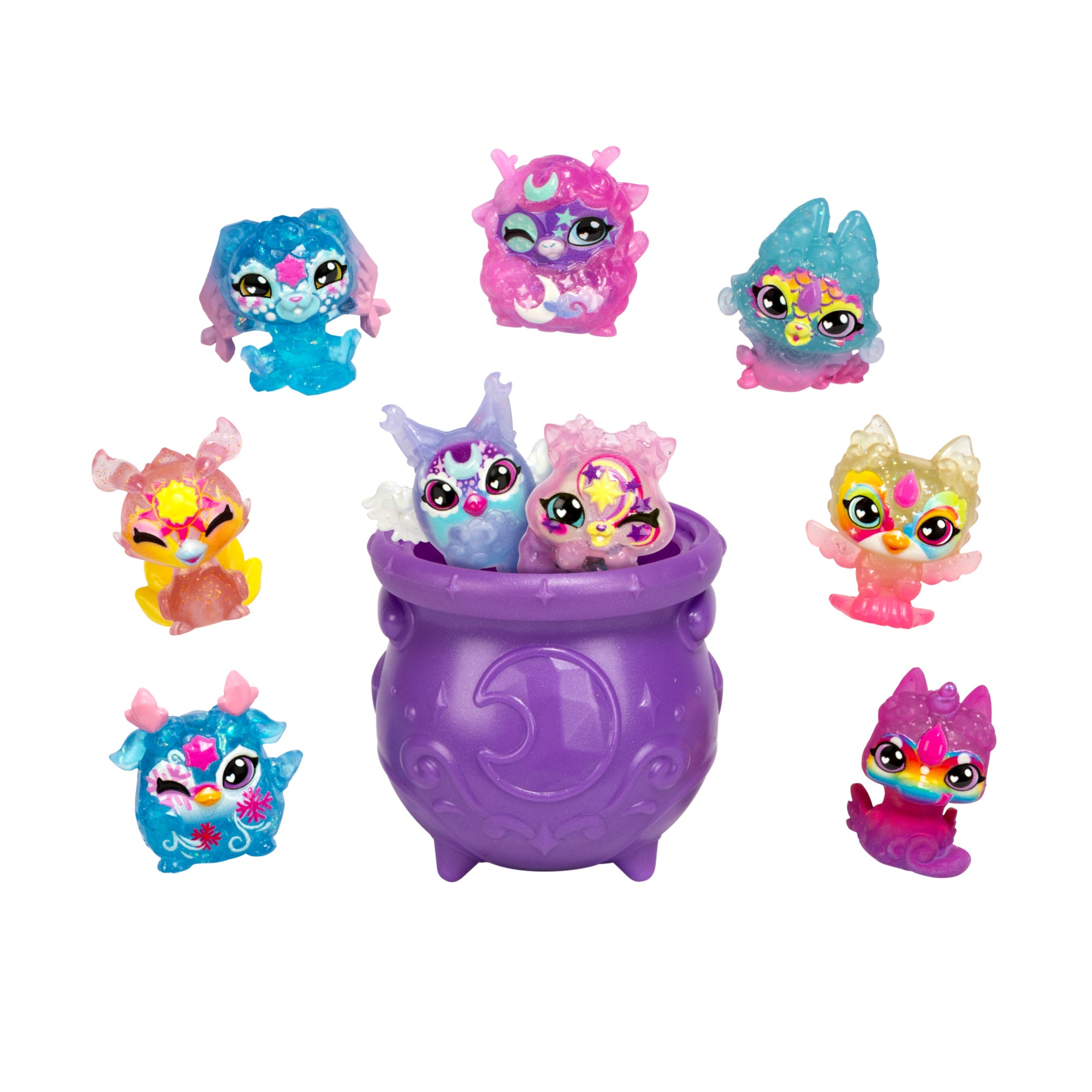Eight sparkling Magic Mixies Mixlings S1 9PK Super Sparkle figures surround a purple, crescent moon cauldron. Two collectible toys are inside, while six with big eyes and unique details are arranged around it.