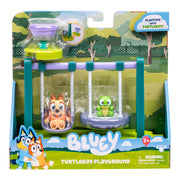 Toy packaging for 'Bluey' featuring two characters on a playground set with a scenic background.