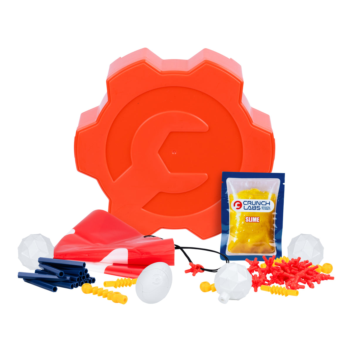 The Crunch Labs Crunch Kit Skyfall Egg Drop by Moose Toys features an orange gear-shaped case, toy launcher, plastic tubes, balls, yellow slime packet, and red-and-white toy pieces displayed on a white background—ideal for a creative Egg Drop Challenge or as a hands-on STEM activity.