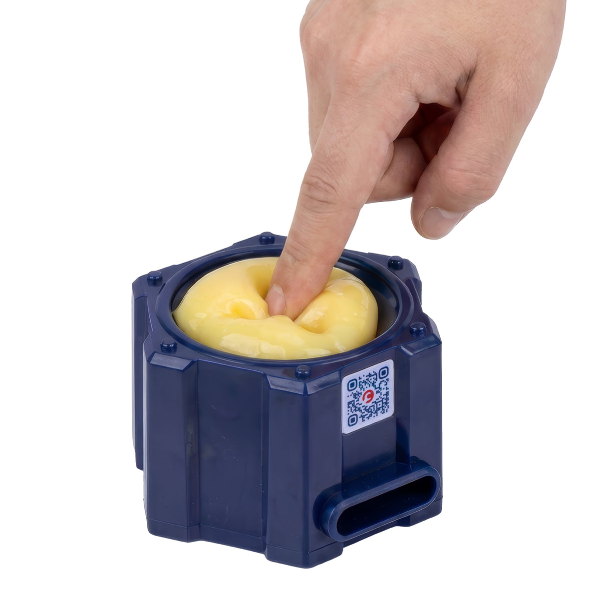 A hand presses a finger into a yellow, gel-like substance inside a blue hexagonal container from the Crunch Lab Crunch Kit Slime Prank Lab by Moose Toys.
