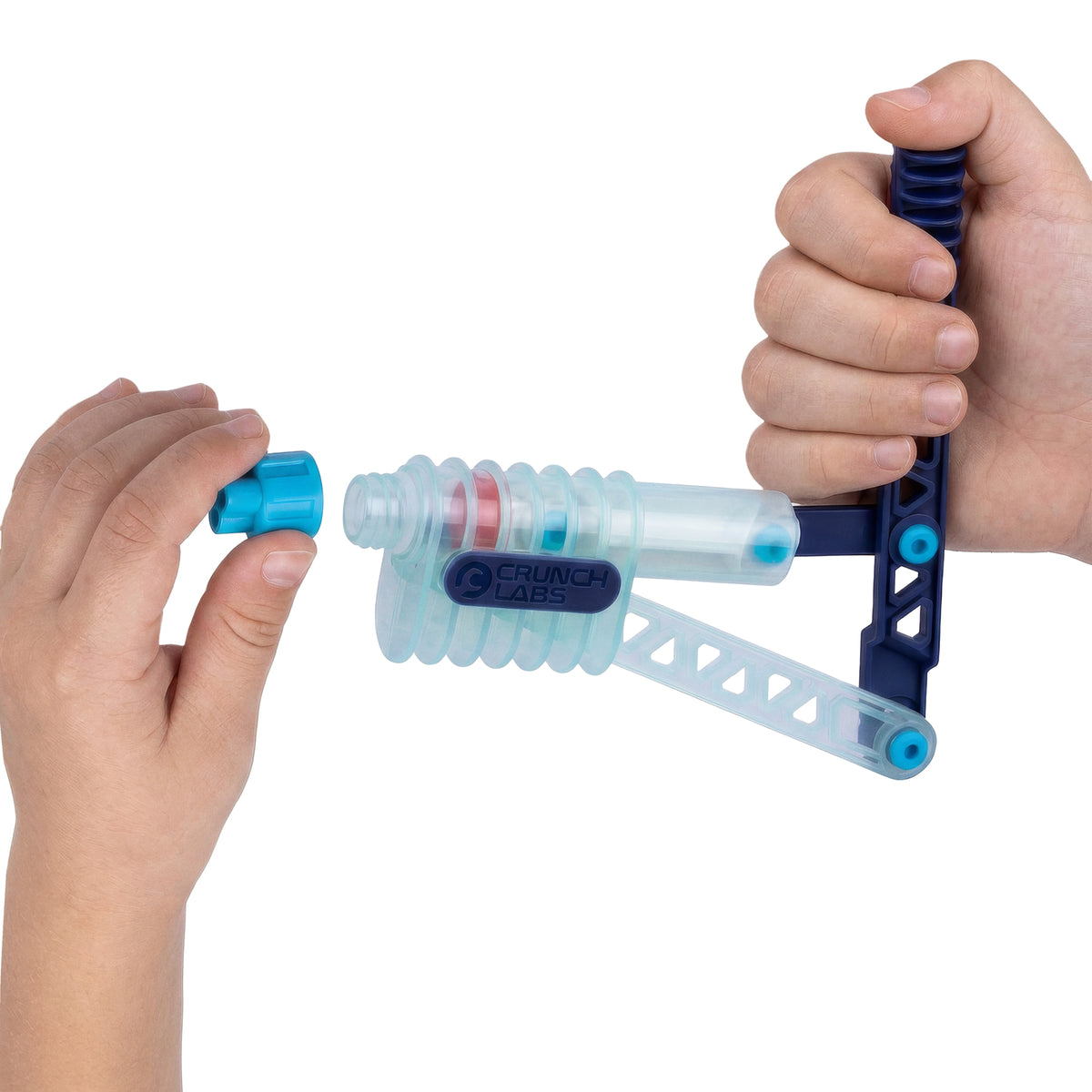 A person holds a blue and clear plastic Crunch Lab Crunch Kit Slime Prank Lab from Moose Toys, turning a handle with one hand and adjusting a blue cap with the other.