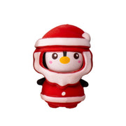The Toysmith Christmas Penguin Squeezy features a cute penguin in a red and white Santa outfit with rosy cheeks and a yellow beak, perfect for holiday stress relief or as stocking stuffers, shown against a white background.