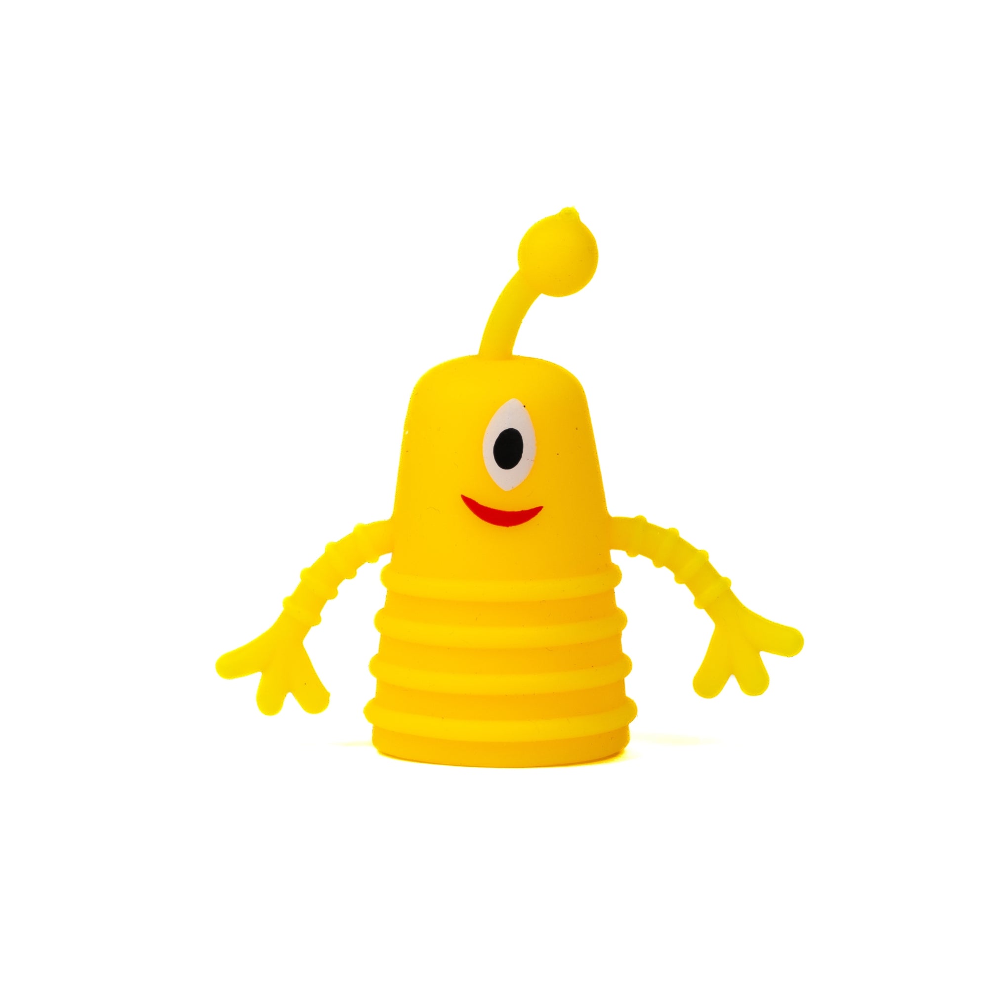The Toysmith Monster Finger Puppet by Toysmith features a yellow, cone-shaped cartoon figure with one eye, a red smiling mouth, long wavy arms, and an antenna on its head, all set against a white background.