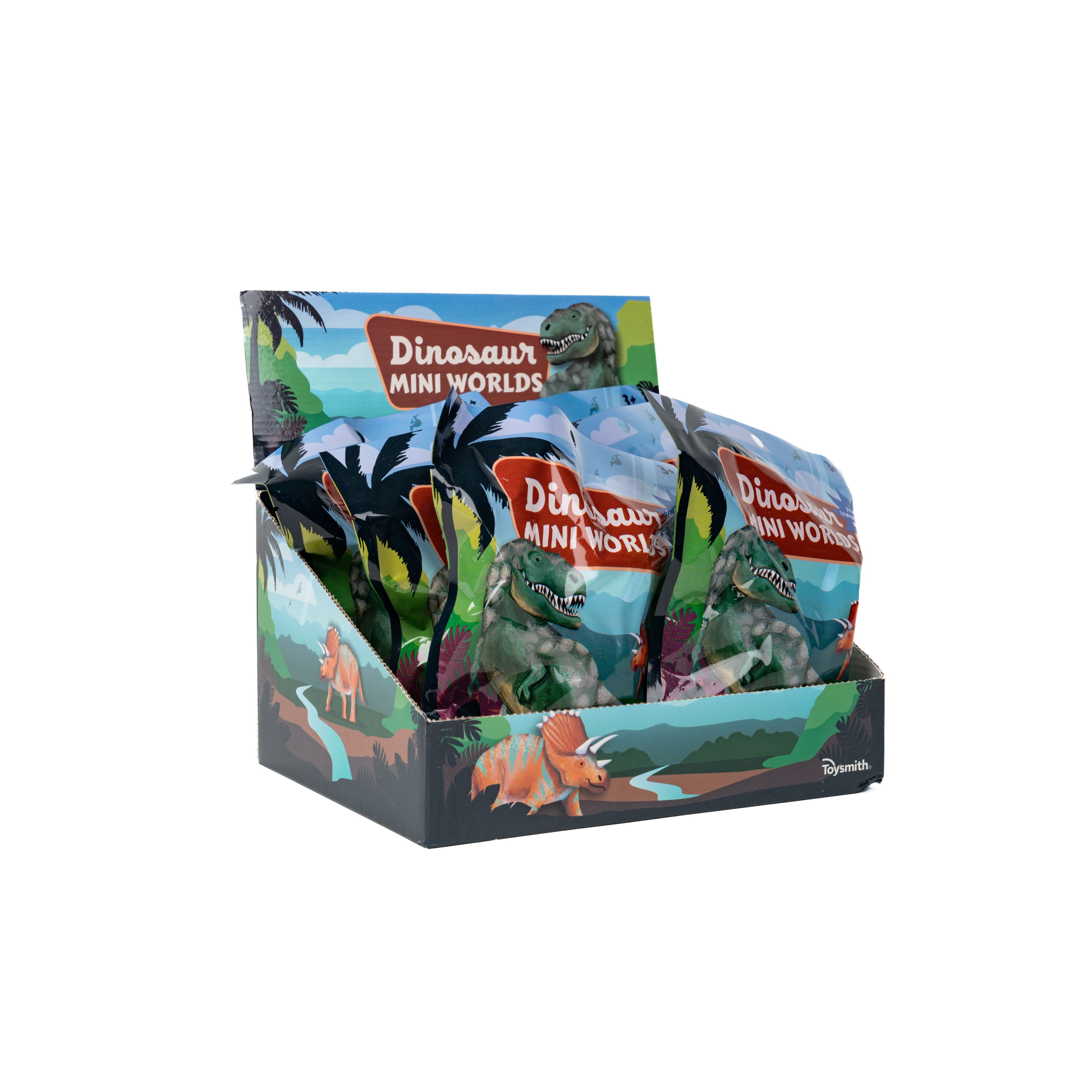 An open display box of Toysmith Dinosaur Mini Worlds Miniature Dino Figurine Toys, each pack featuring a dinosaur figurine in jungle-themed packaging—ideal for collectors or as a playful toy backpack addition.