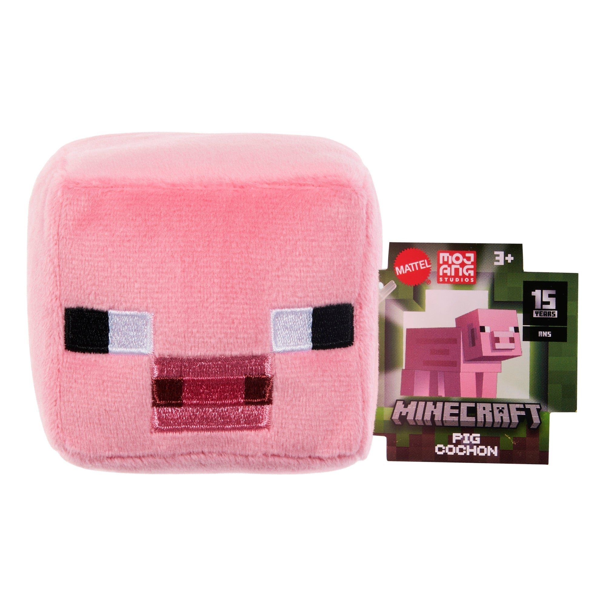 The Mattel Minecraft Basic Block Plushie is a pink, cube-shaped pig with pixelated features and a “Minecraft Pig Cochon” tag, designed for ages 3 and up.