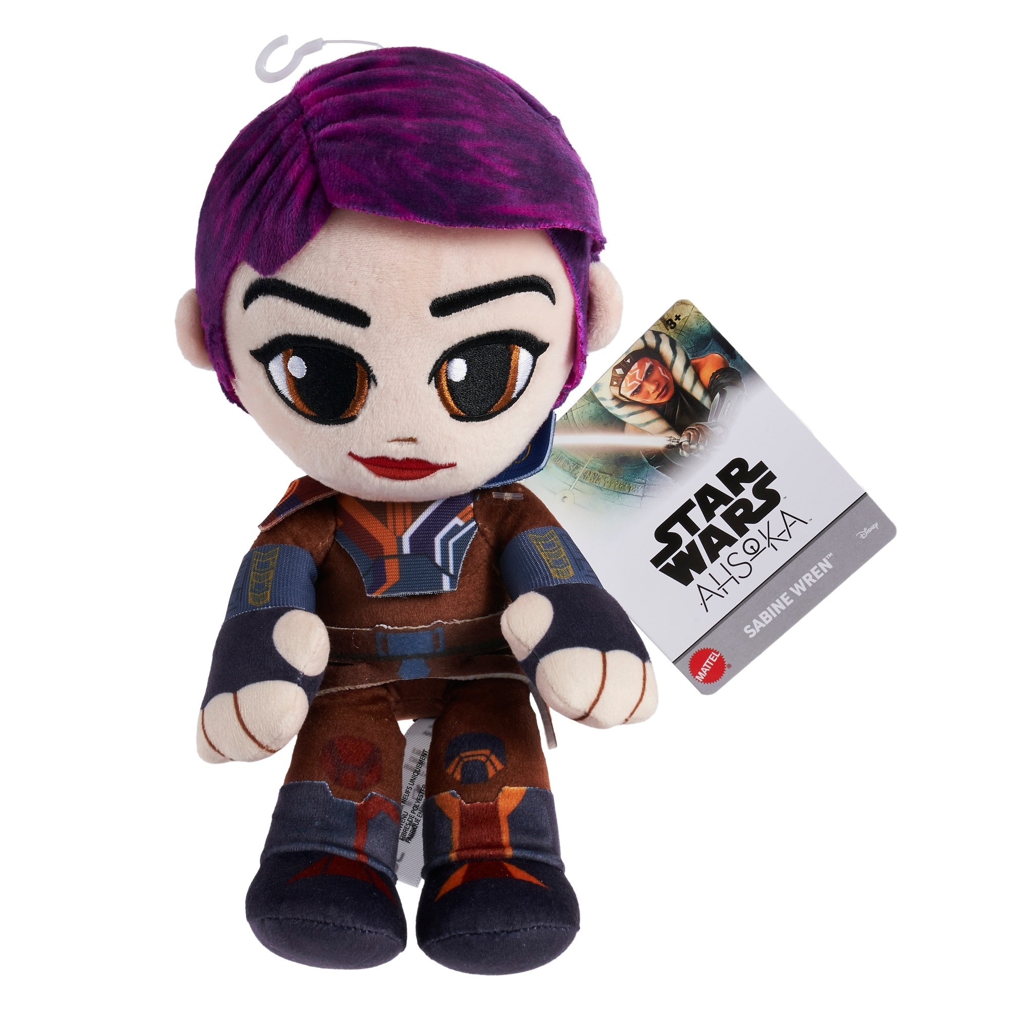 The Mattel Star Wars 8in Plushie is a soft Sabine Wren doll with purple hair, vibrant Mandalorian armor, and an attached tag showing her image and the Star Wars: Ahsoka logo.