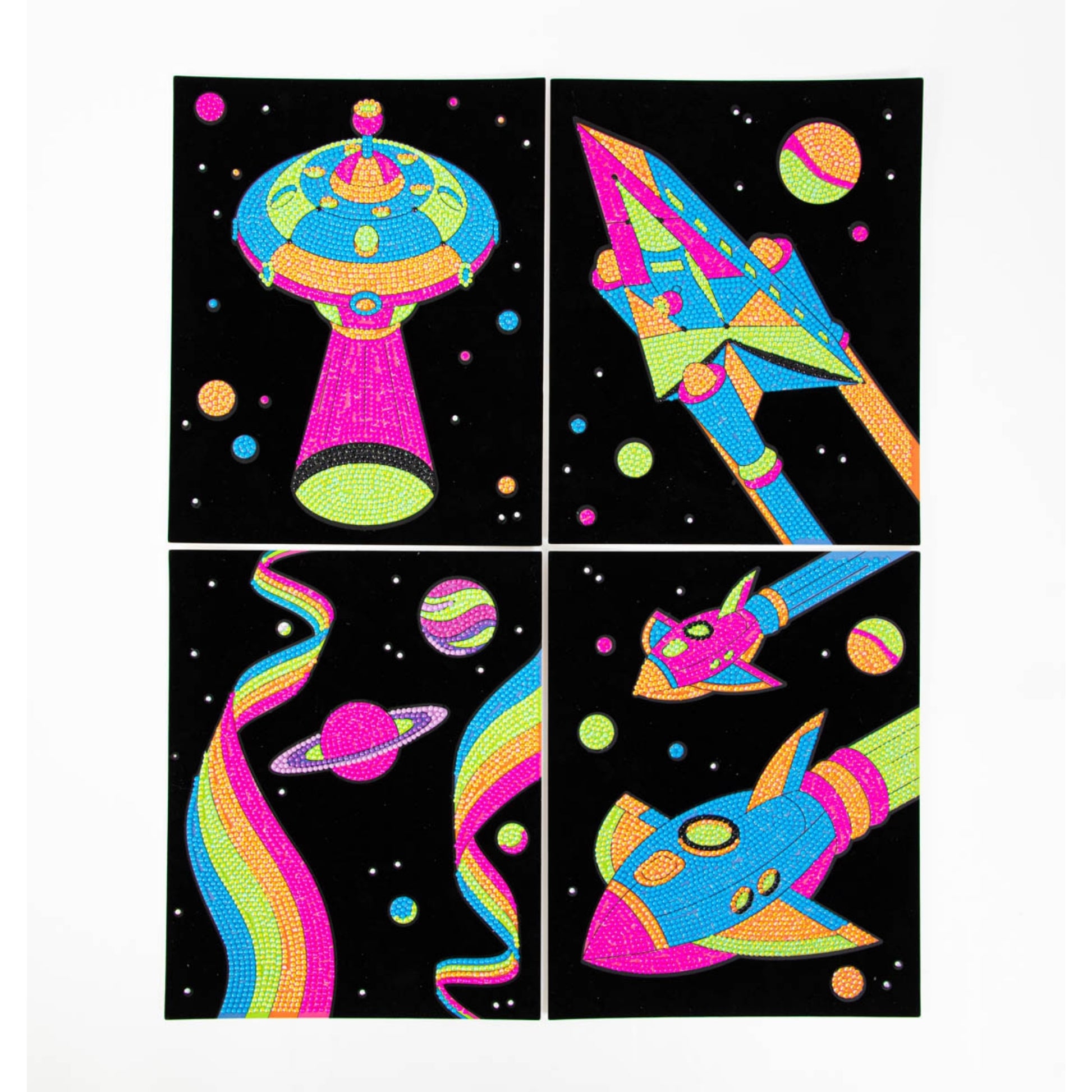 Diamond Dotz Dotzies Neon Flock features four vibrant scratch art panels with neon UFOs, rockets, planets, and rainbows set against a star-filled black space background.