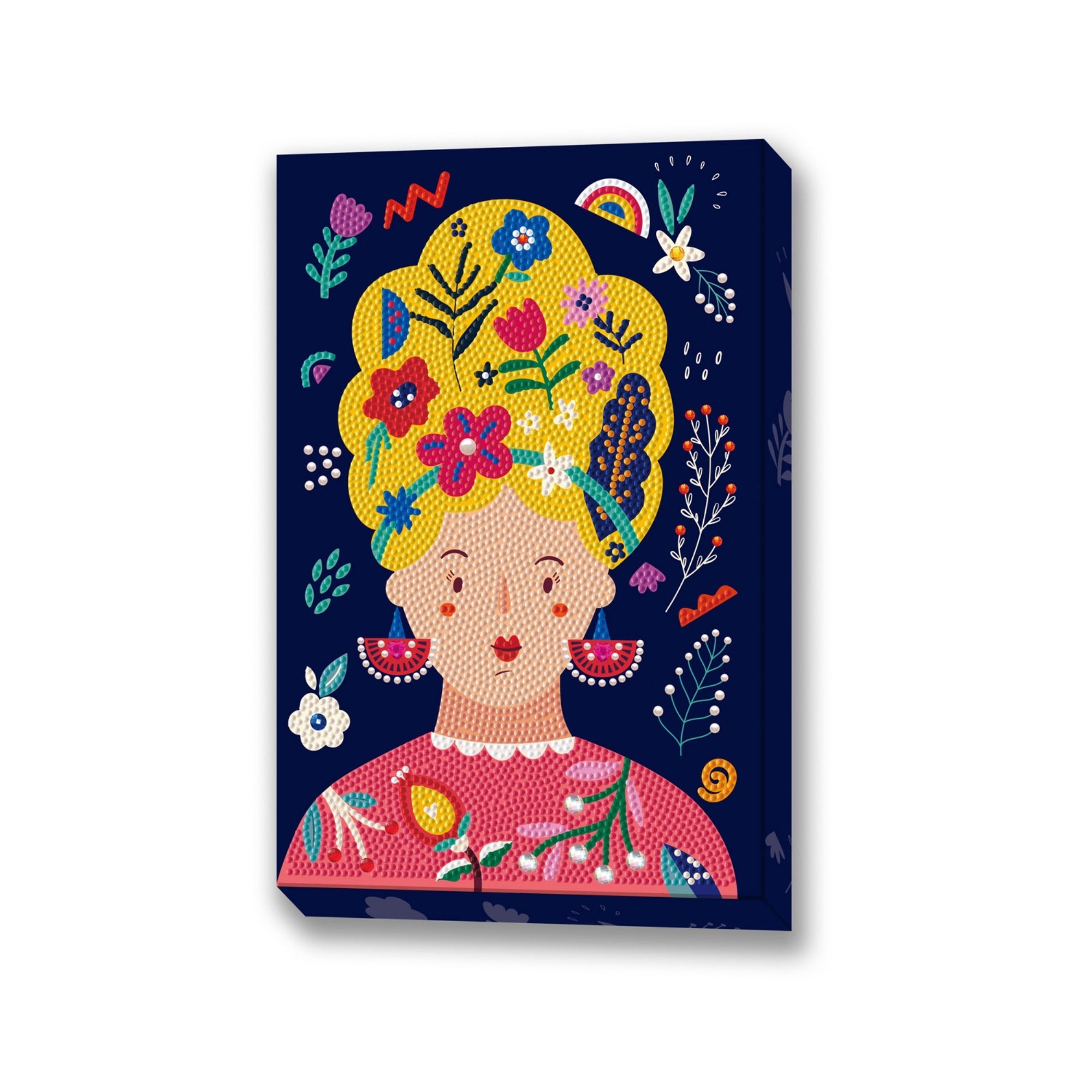 Diamond Dotz Large Dotz Decor features a vibrant woman with bright yellow hair adorned with flowers and leaves, large pink earrings, and a pink top, set against a dark blue floral background.