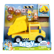 The Bluey Dump Truck toy set includes a yellow dump truck, Hard-Hat Bluey and Wheeee! Bingo figures, three brown balls, and comes in Bluey-themed packaging for kids ages 3+.