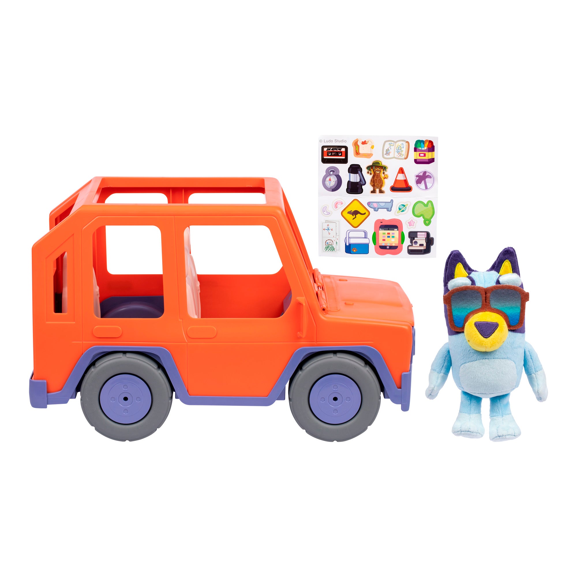 The Bluey Buddies Big Heeler 4WD Car Playset includes an orange toy car, a plush blue dog with red sunglasses, and a sheet of colorful stickers featuring various designs.