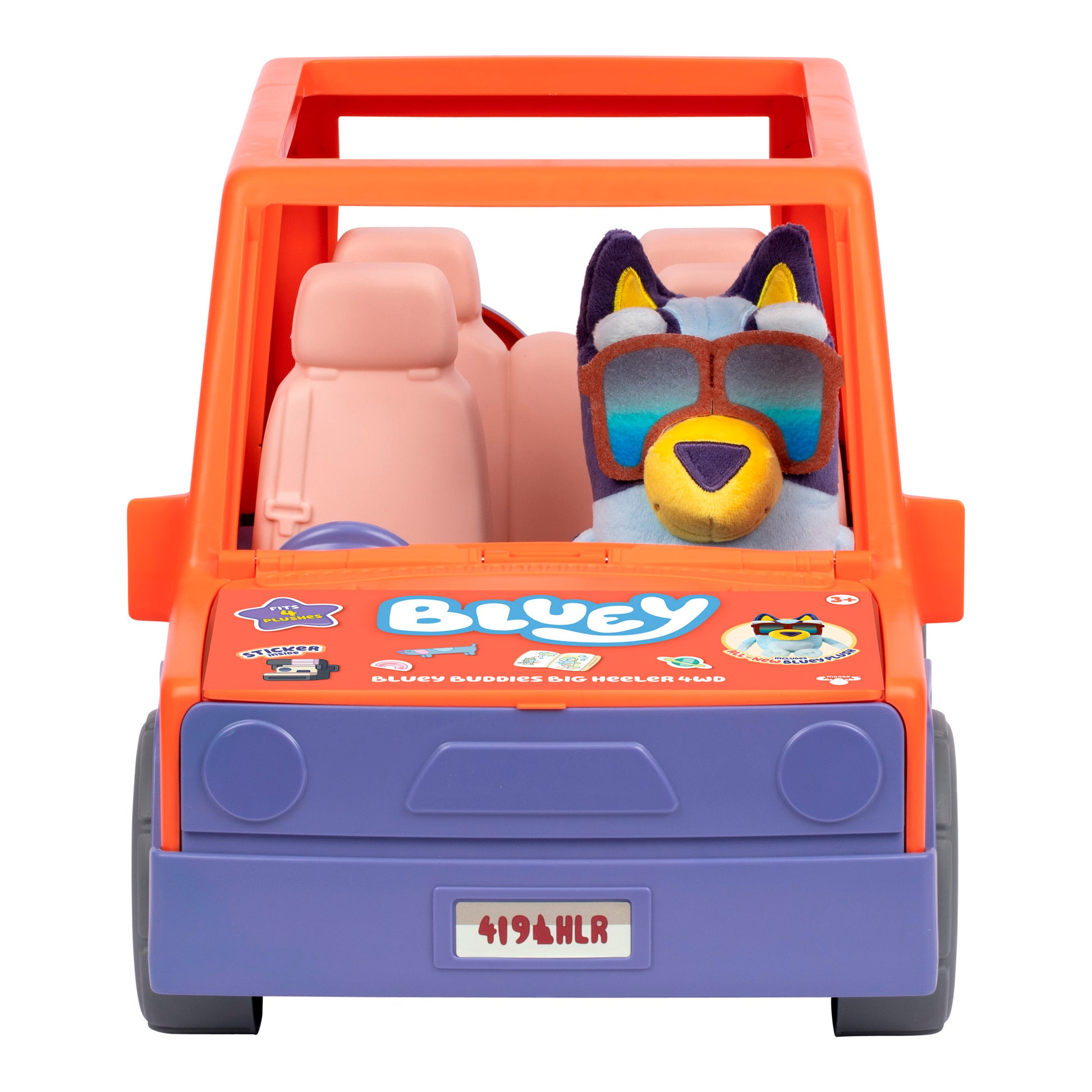 A plush Bluey dog with large sunglasses sits in the driver’s seat of the Bluey Buddies Big Heeler 4WD Car Playset, a toy car featuring orange and purple colors, “Bluey” branding, and cartoon graphics on the hood.