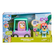 The Bluey Chat Mates Janet Playset includes a purple and green toy car, a Bluey figure with glasses, pink keys, and colorful packaging with Bluey character illustrations.