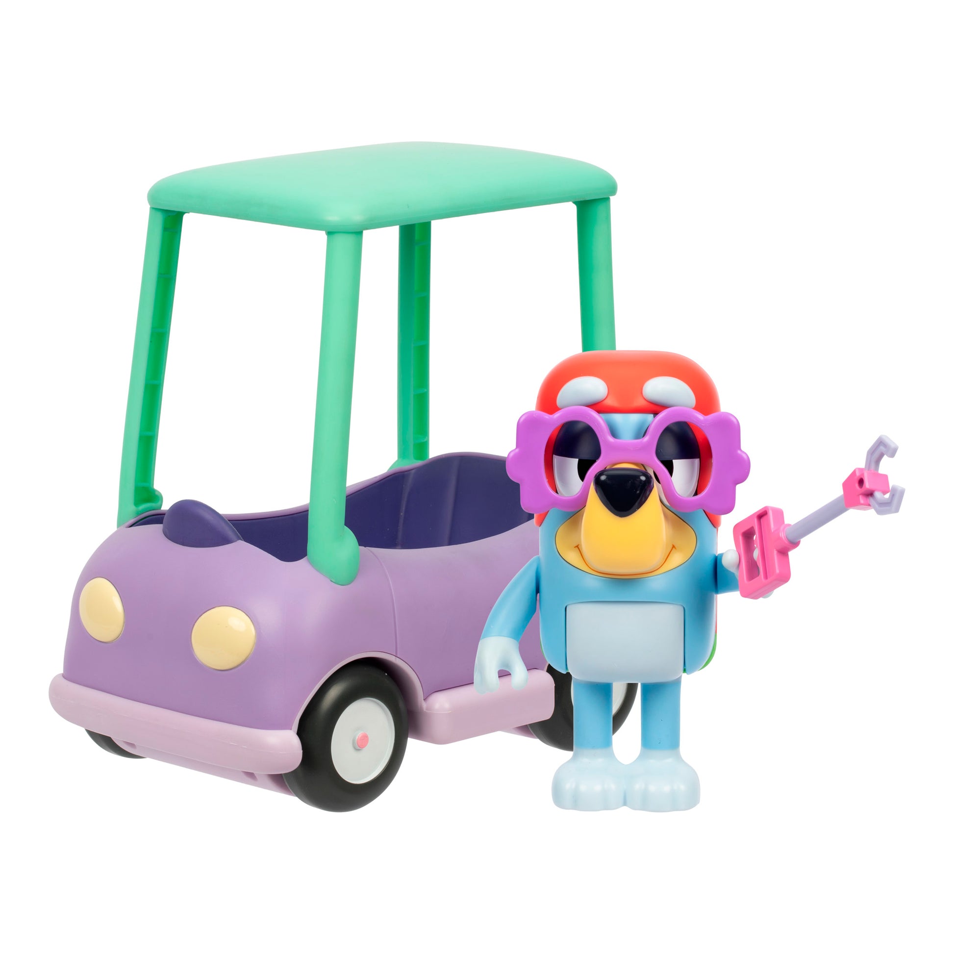 The Bluey Chat Mates Janet Playset features a colorful toy dog with sunglasses, a red hat, and a key standing beside a purple and green toy car with a roof and round headlights.