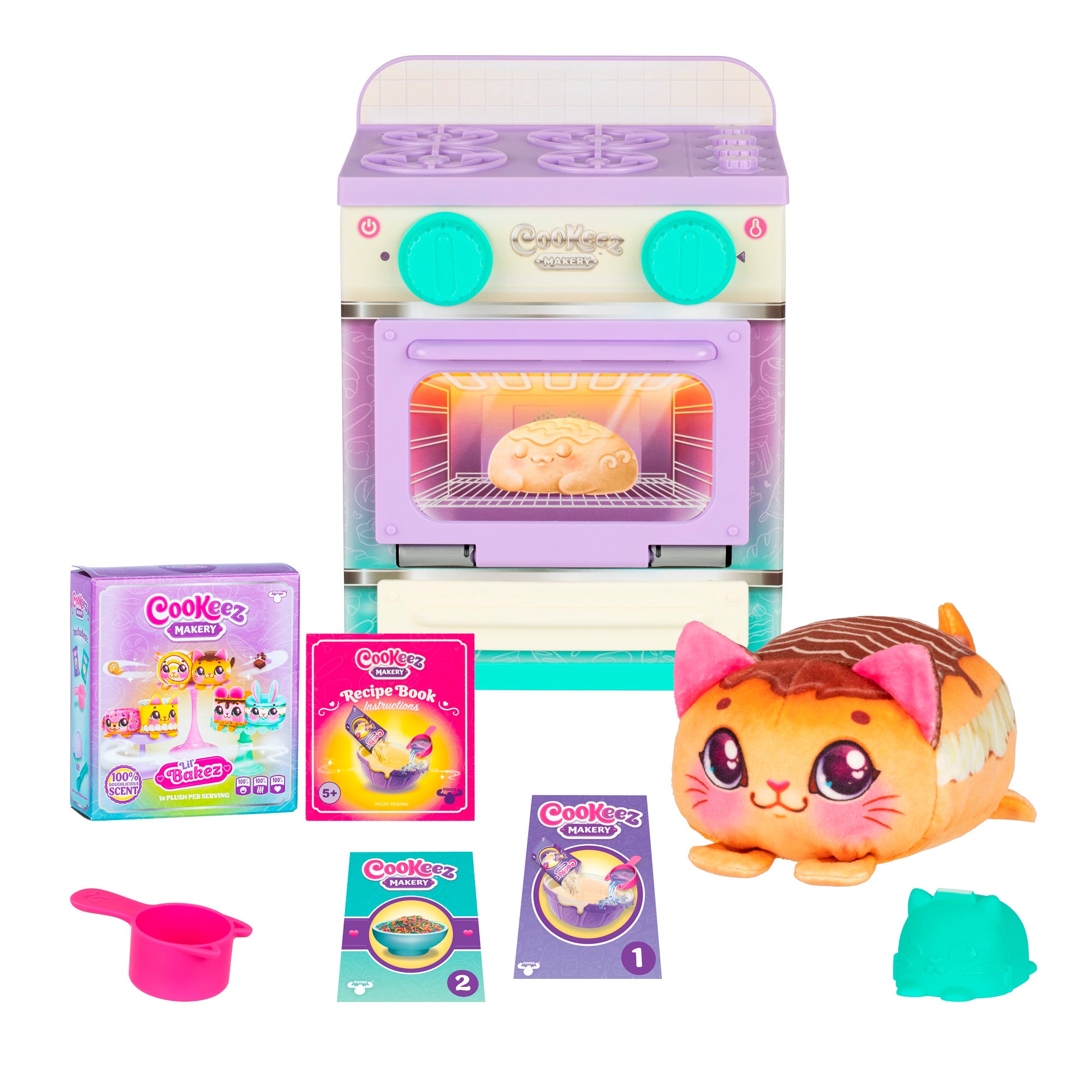 The Cookeez Makery Lil' Bakez Playset features a pastel oven with a door revealing plush cat-shaped bread, recipe cards, measuring cup, green mold, and comes with a Cookeez Makery box and recipe book.
