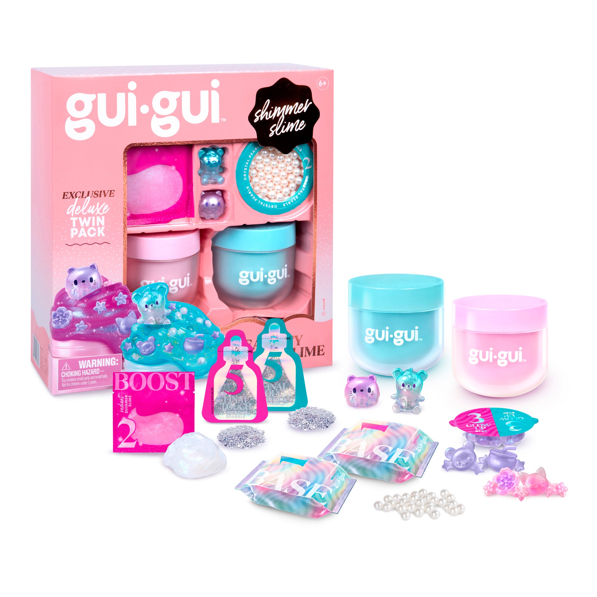 A Gui Gui Shimmer Deluxe Duo Pack is displayed with its box, two jars of slime, glitter packets, beads, small animal figurines, and other accessories arranged in front.