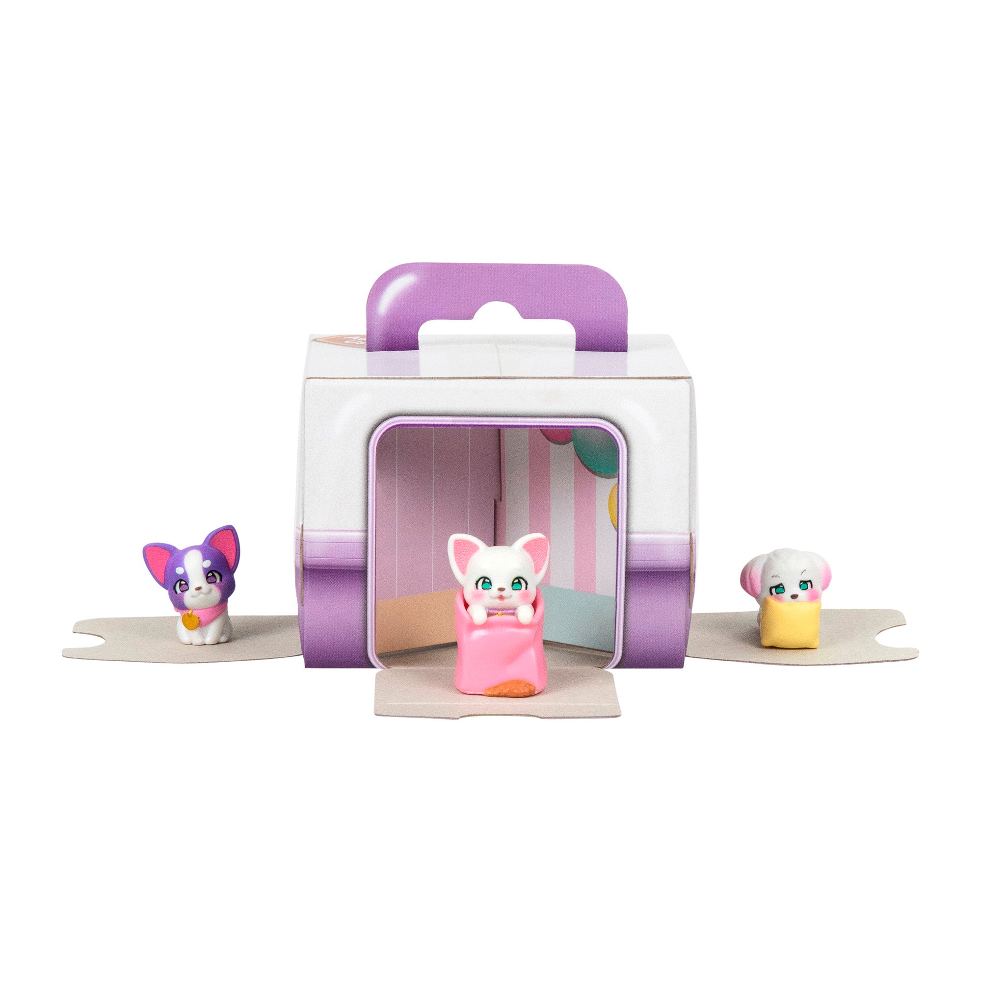 Three small, colorful animal figurines from the LLP Mama Surprise Families Adoption Pack are displayed in front of an open, purple-handled box with pastel stripes. The pink figure with large ears is between purple and white figures.