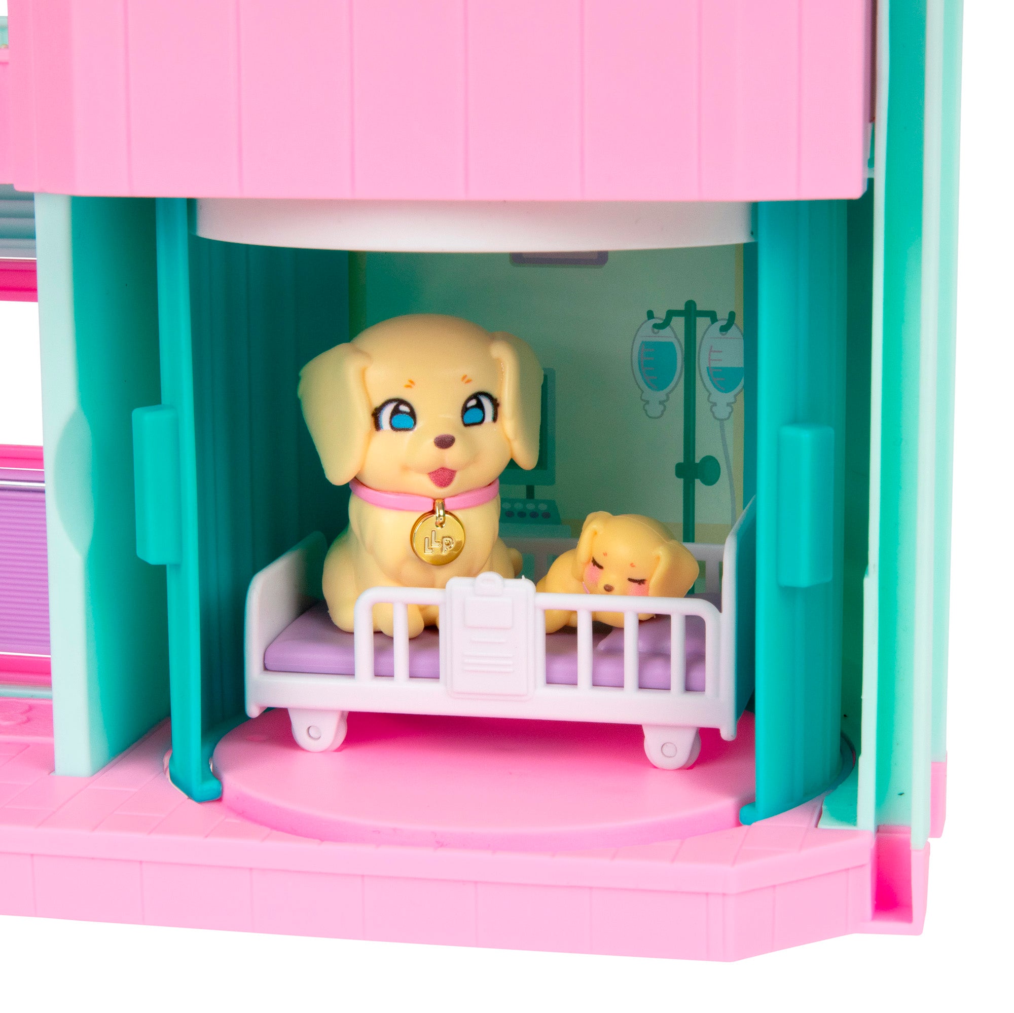 The LLP Mama Surprise Families Veterinarian Playset features a toy dog and puppy on a hospital bed in a vibrant room with teal, pink, and purple accents—ideal for imaginative pet care clinic adventures.
