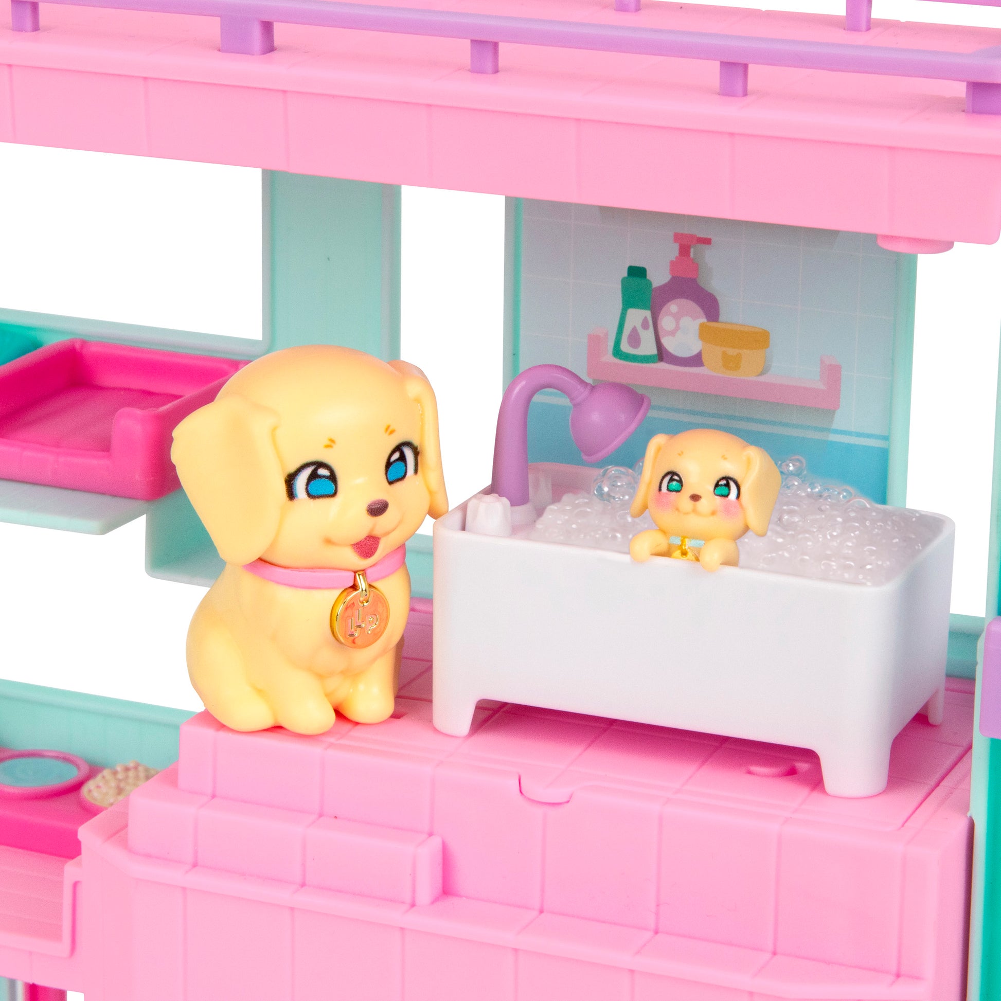 In the LLP Mama Surprise Families Veterinarian Playset, two toy puppies enjoy bath time in a mini clinic bathroom, with one by the tub and the other playing in bubbles. Pink and teal shelves and accessories complete this adorable pet care scene.