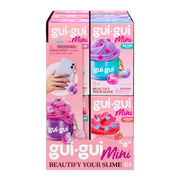 Moose Toys Gui Gui Minis Backpack Charm Slimes display box for ages 6+, featuring purple and pink mini slime containers, "Beautify Your Slime" slogan, sensory play appeal, and a photo of the accessory being held.