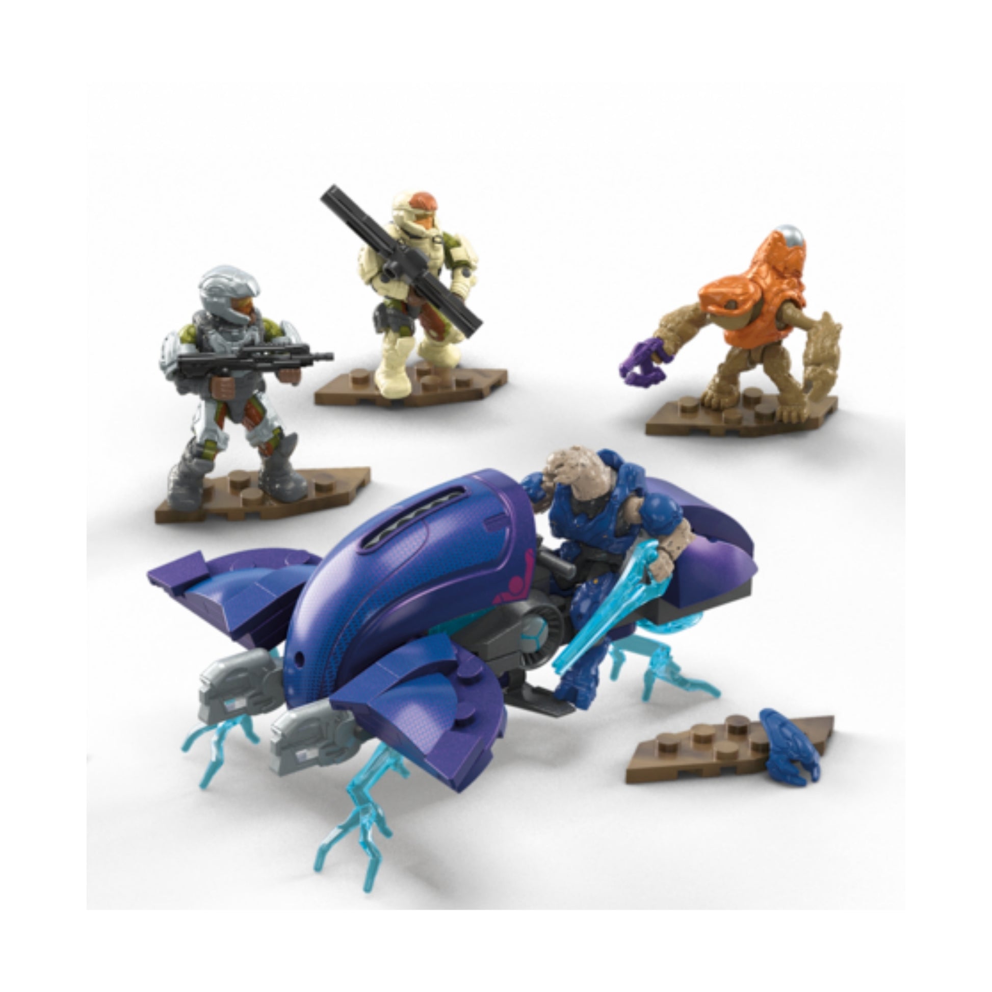Four Spartan micro action figures with weapons are posed on tan stands around a purple vehicle with blue energy effects from the Mega Blocks Small Vehicles Collection—perfect for any Halo fan's display.