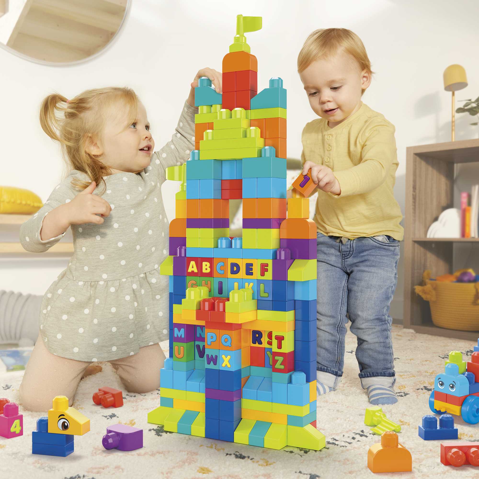 Two children playing with colorful building blocks in a room.