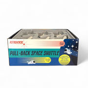 A colorful Astroverse box labeled "Astroverse Pull Back Space Shuttle" contains several 5-inch diecast metal shuttles. The packaging features space-themed graphics with an astronaut, stars, and text highlighting their realistic details.