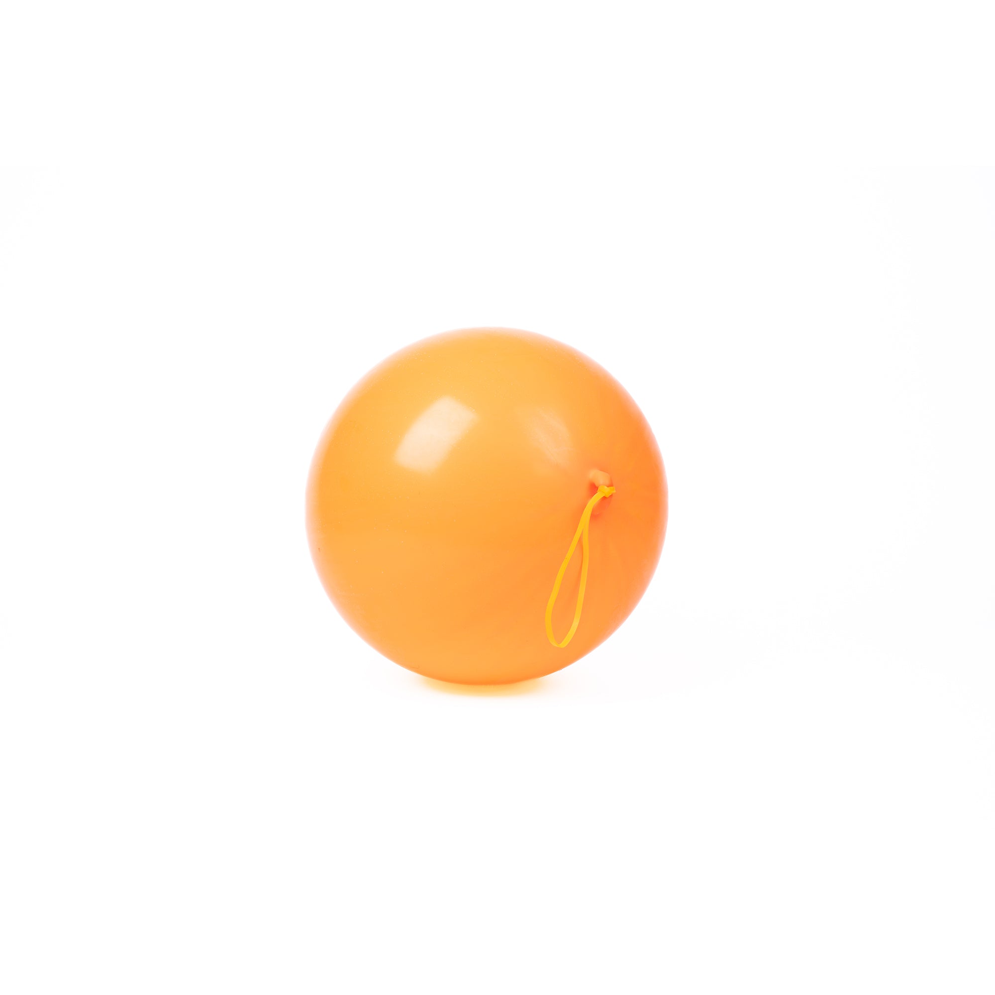 A single Neato! Punch Balloon in orange with a yellow rubber band attached, perfect for active play, from the Neato! brand, shown on a white background.