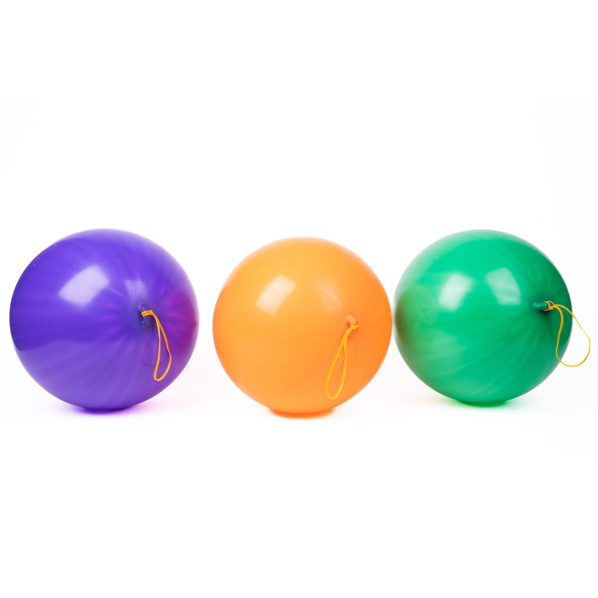 Three large Neato! Punch Balloons—purple, orange, and green—are lined up side by side against a white background. Each balloon from Neato! features a yellow elastic loop for active fun.