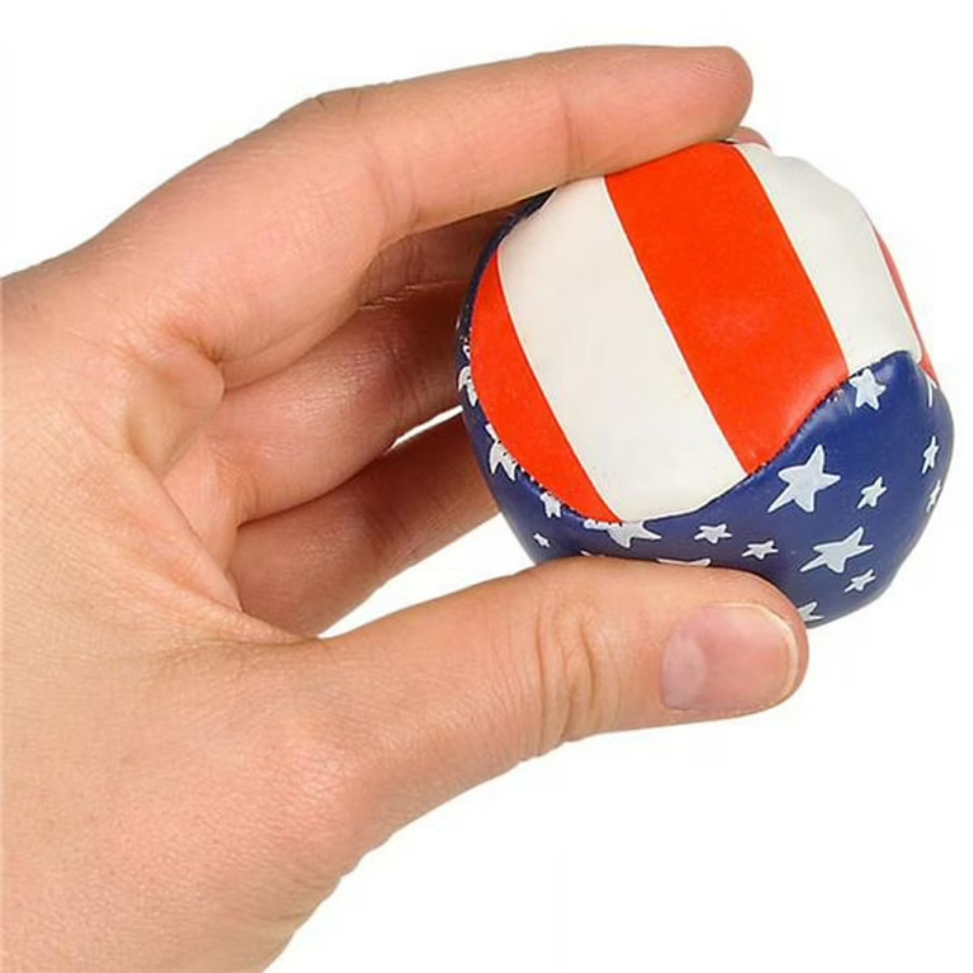 A hand holds the Toysmith 2in USA Hacky Sack by Toysmith, a small round footbag decorated with red, white, and blue like the American flag—a perfect portable toy for fun anywhere.