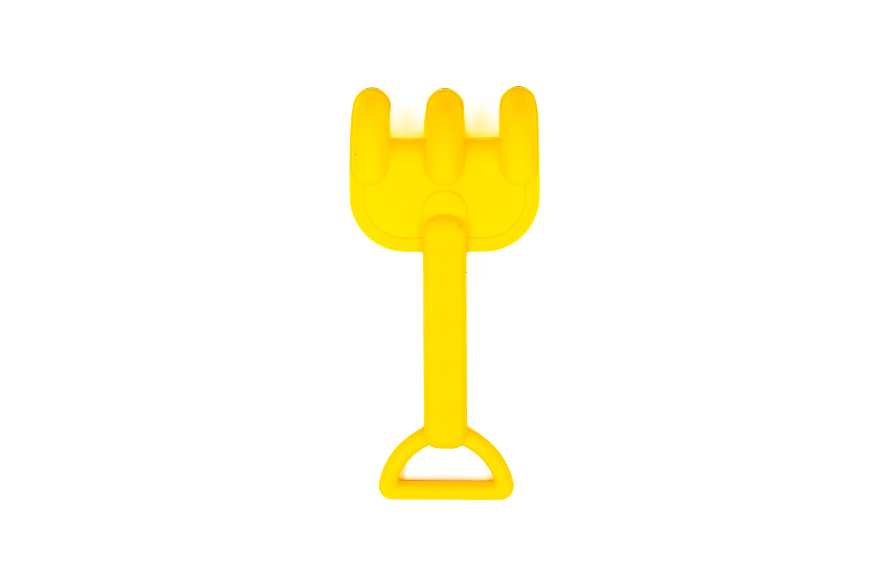 The image shows a small yellow plastic rake with three prongs and handle, part of the Toysmith 6pc Set Pink Sand Bucket Set by Toysmith, commonly used by children for playing in sand. White background.