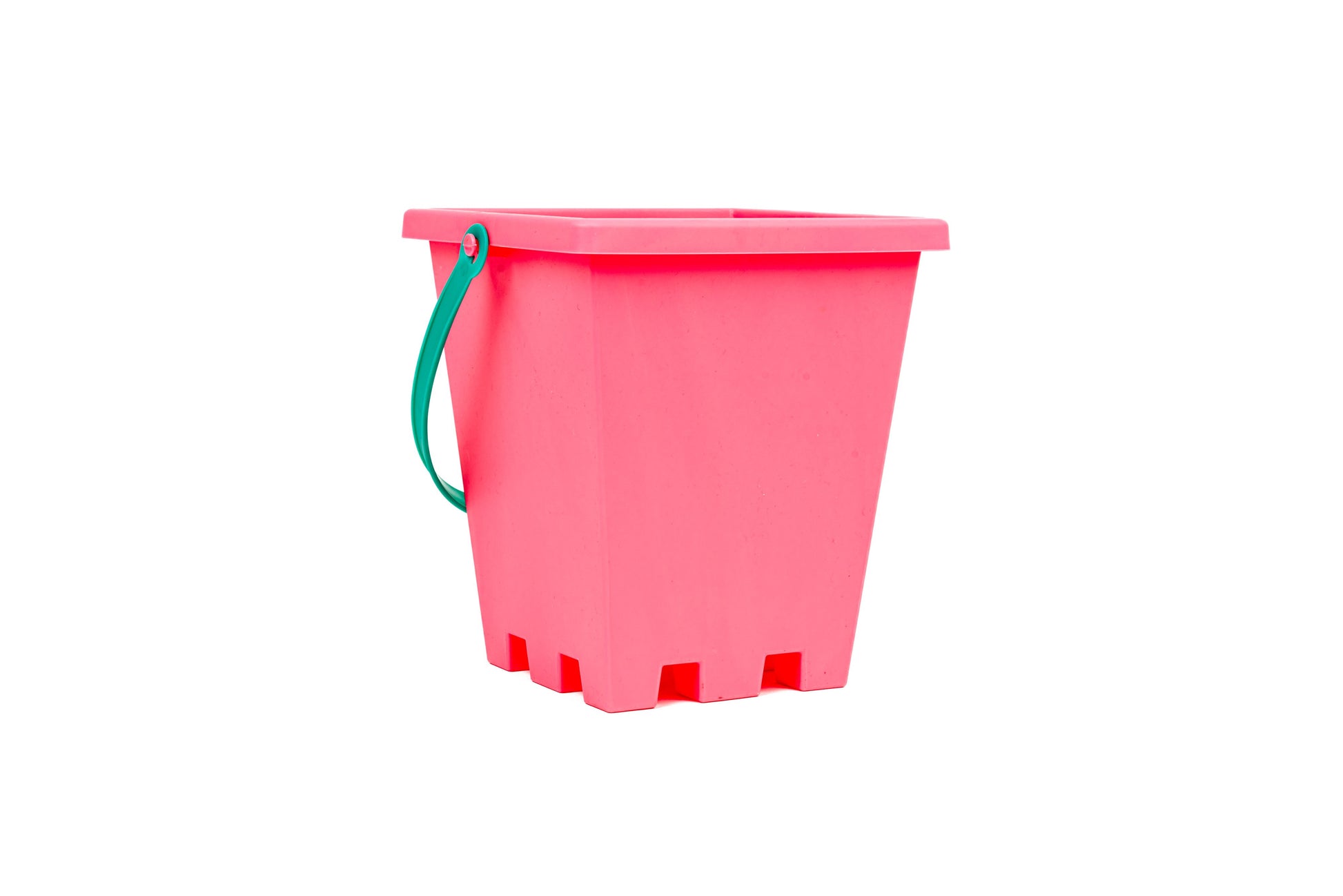 The Toysmith 6pc Set Pink Sand Bucket Set by Toysmith features a bright pink rectangular plastic bucket with a green handle, ideal for beach toys or sandcastle molds, and is shown isolated on a white background.