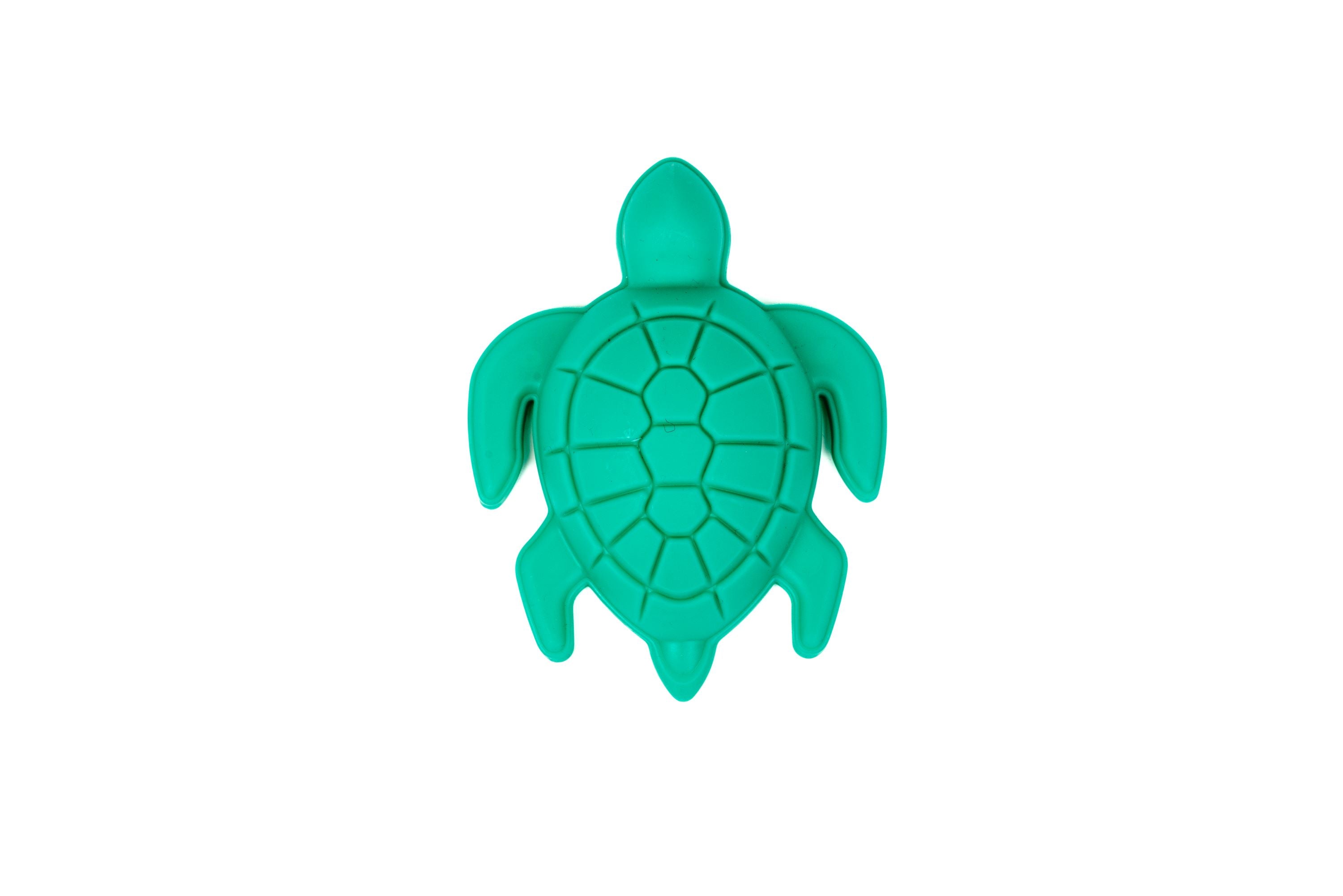 The Toysmith 6pc Set Ship Sand Bucket Set includes a green turtle-shaped plastic mold with a segmented shell design, ideal for beach play or building sandcastles. From Toysmith, shown from above on a white background.