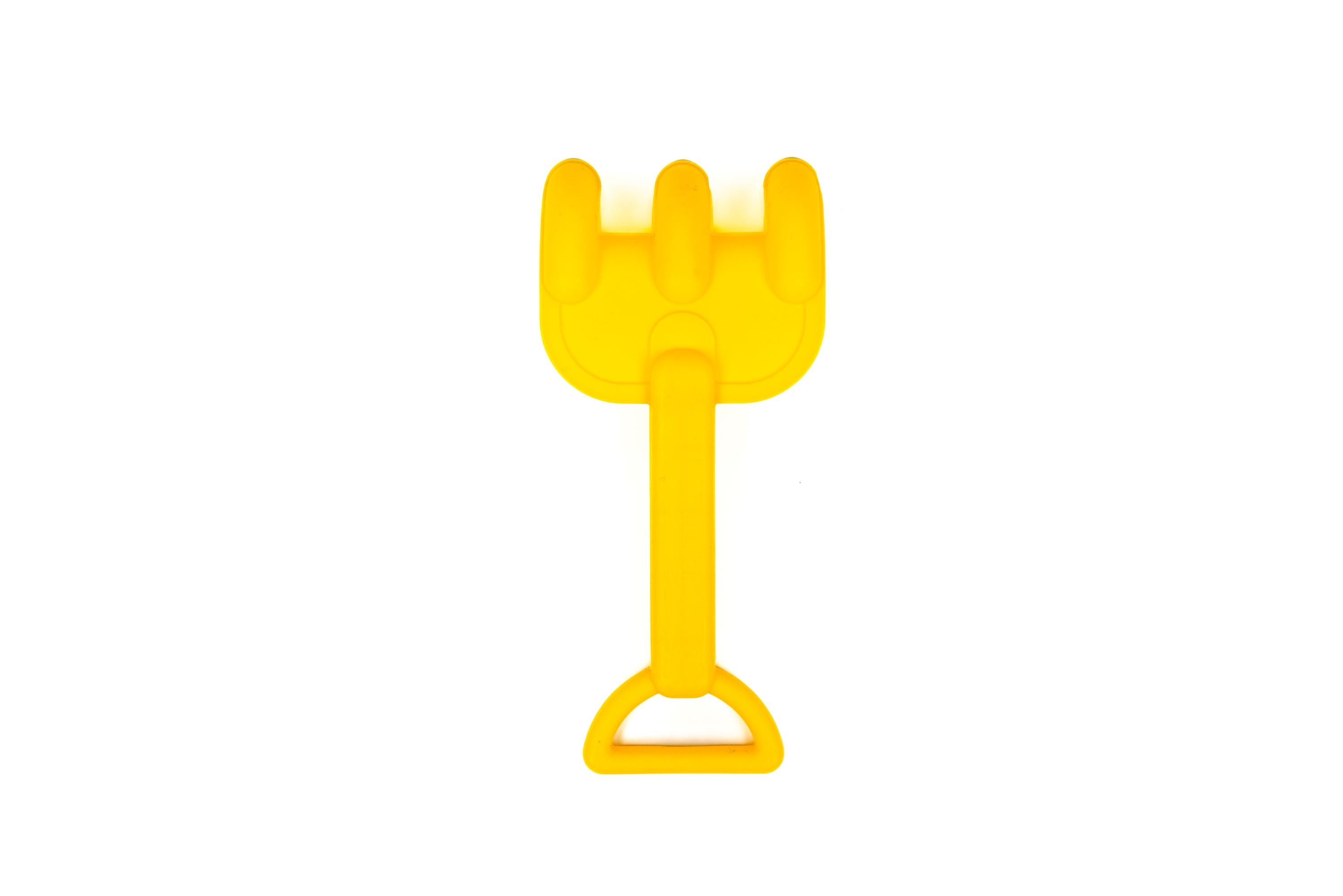 The Toysmith 6pc Set Ship Sand Bucket Set includes a small yellow plastic rake with three prongs and a triangular handle, ideal for beach play, shown here on a white background.