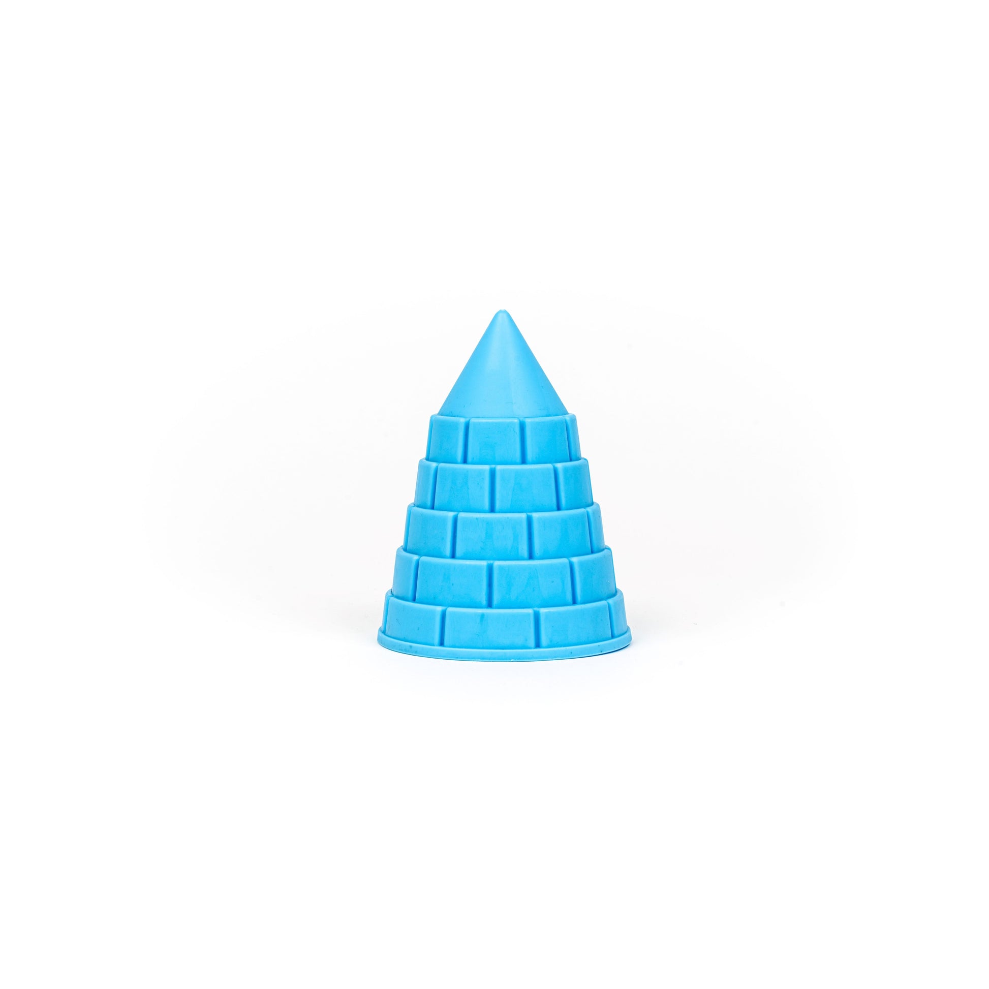 A blue, cone-shaped mold with a stepped, brick-like pattern from the Toysmith 6PC Sand Mold Set by Toysmith is centered on a white background.