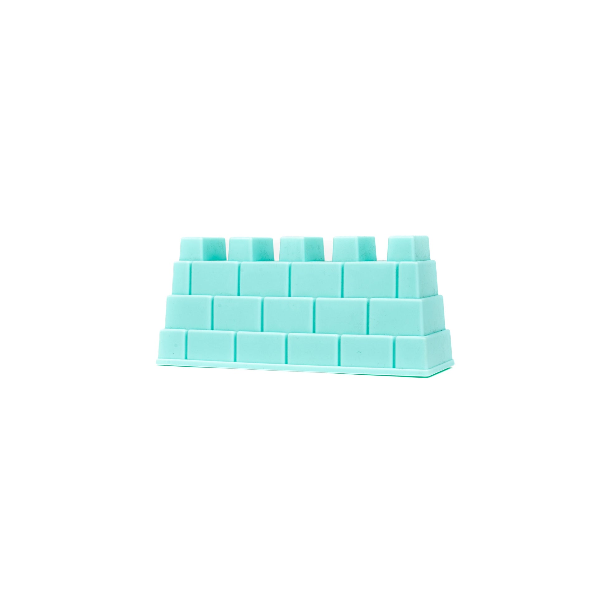 The Toysmith 6PC Sand Mold Set features a turquoise plastic block shaped like a wall section with brick-like rows and a smooth base, perfect for sandcastle building or pairing with other beach toys. Brand: Toysmith.