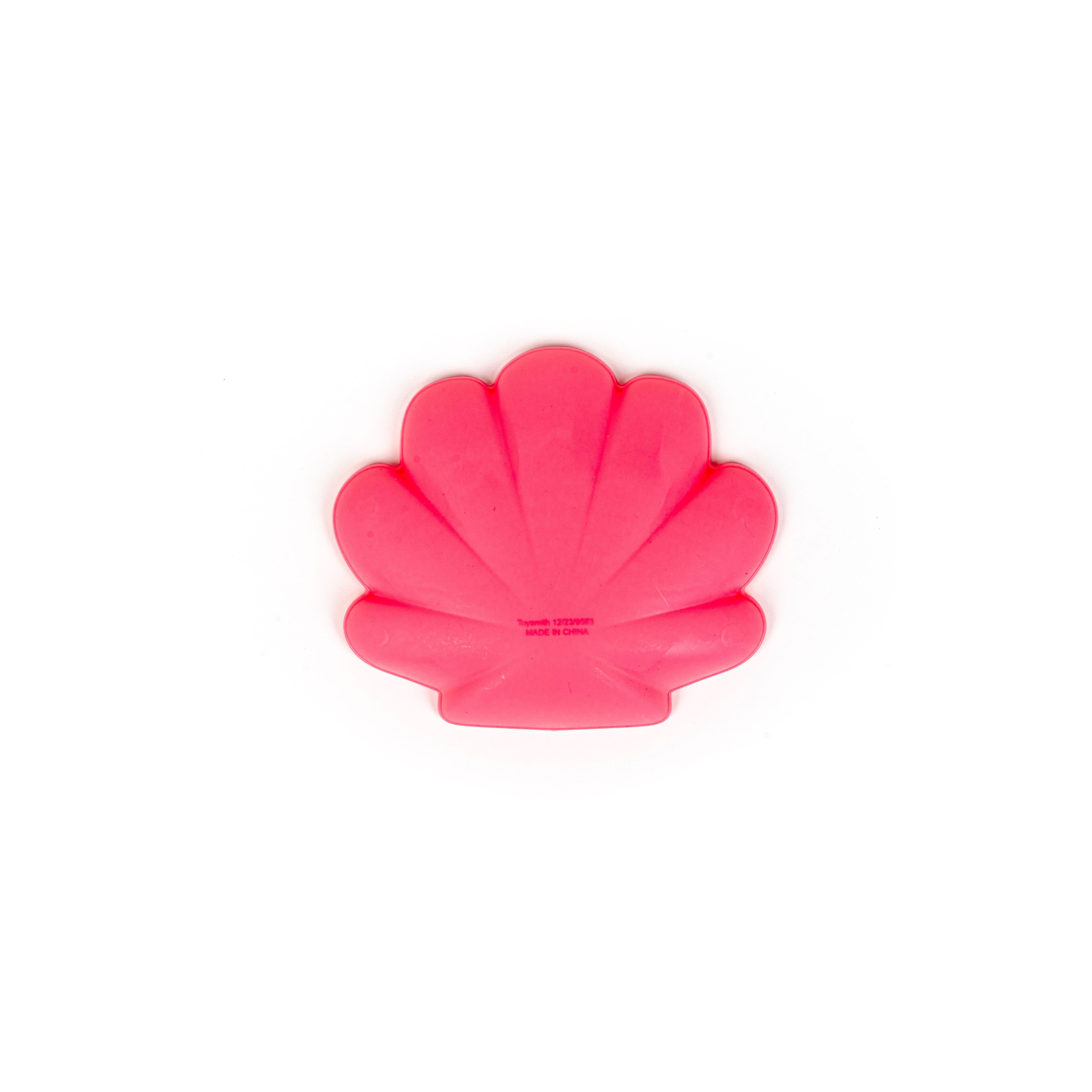 A bright pink scallop shell-shaped mold from the Toysmith 6PC Sand Mold Set by Toysmith, viewed from above on a plain white background.