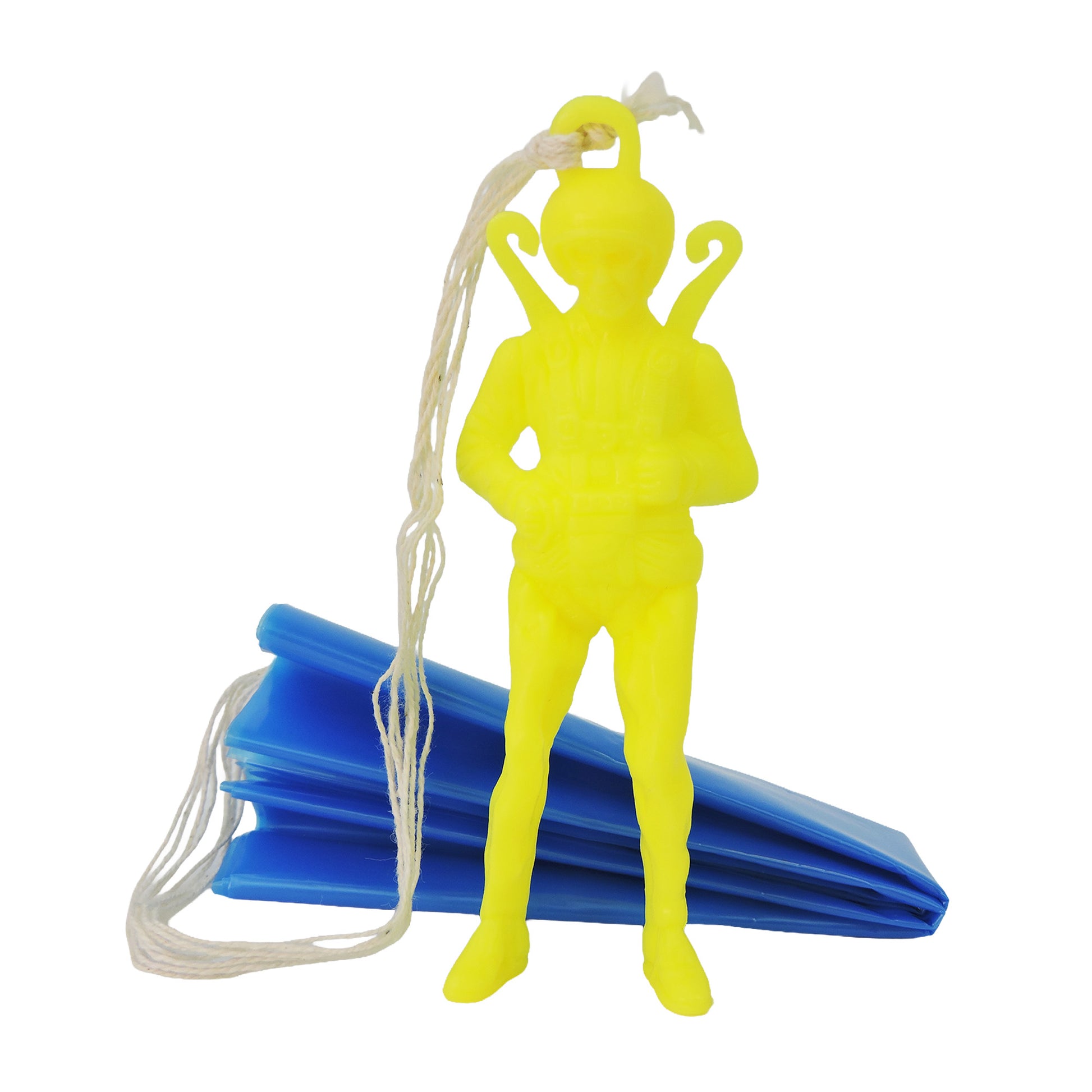 The Toysmith Giant Parachuter Figure by Toysmith is a yellow plastic toy with a parachute pack, posed in front of its folded blue parachute and white strings.