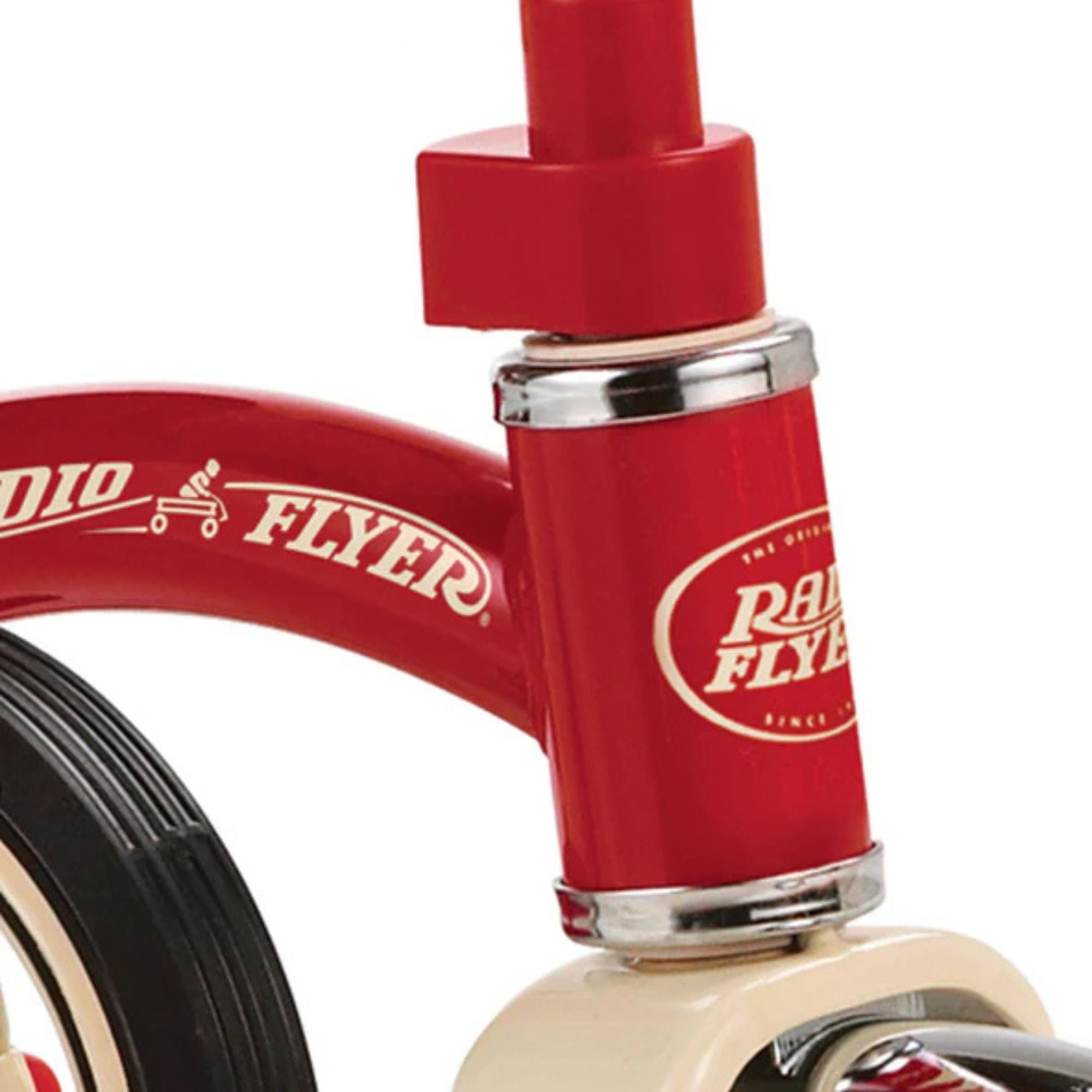 Close-up of the Radio Flyer Classic Red Dual Deck Tricycle frame, featuring part of the front wheel, handlebars, and the iconic Radio Flyer logo.