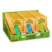 A display box contains multiple Outdoor Discovery Survival Compass packs for ages 5+, featuring bright yellow and green packaging with compass illustrations and labeled as 5-in-1 survival tools.