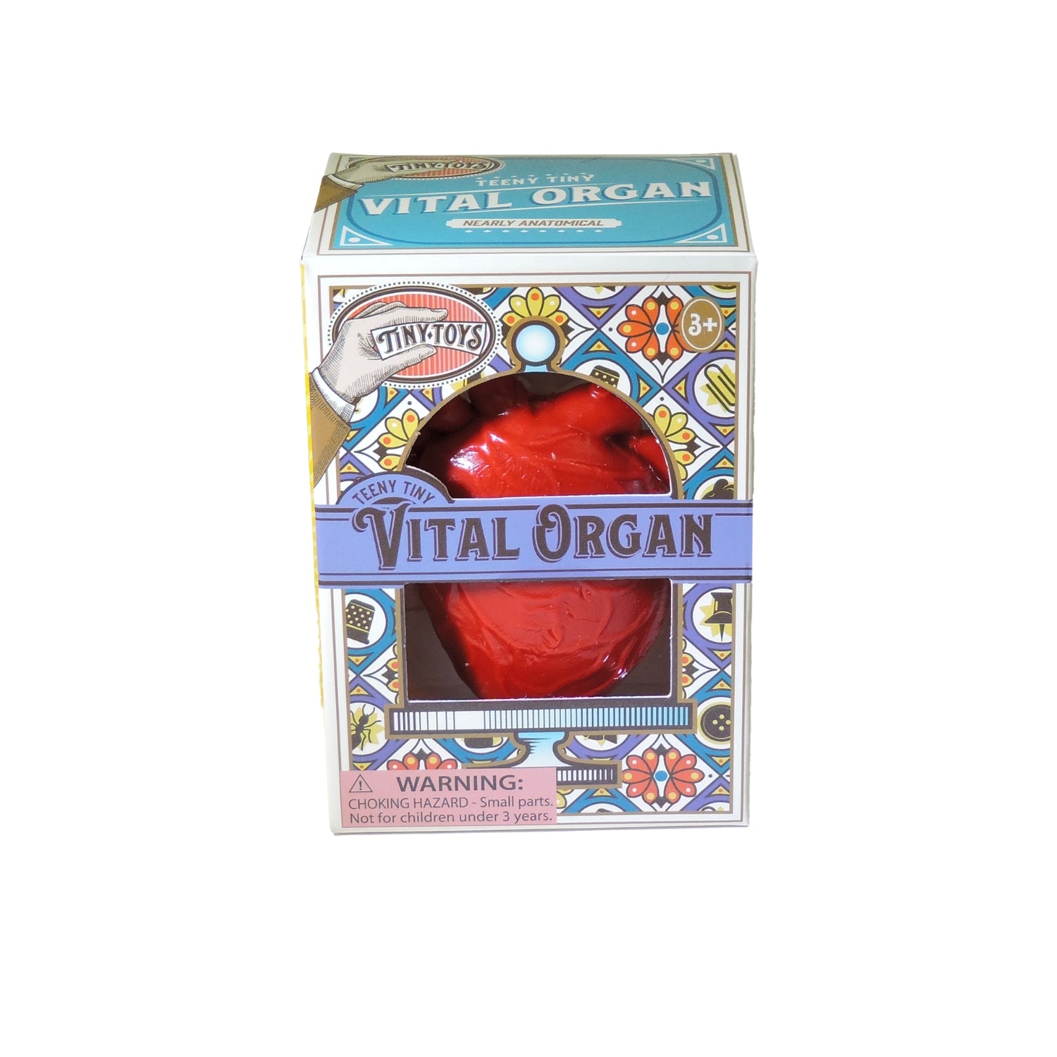 Teeny Tiny Vital Organ is a stress-relieving toy with an anatomically correct heart inside a stained glass-style, colorful box. Suitable for ages 3+, the packaging includes a choking hazard warning.