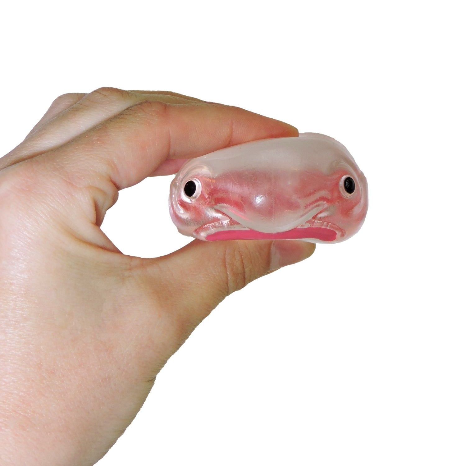 Hand holding a small pink and white fish-shaped object against a white background