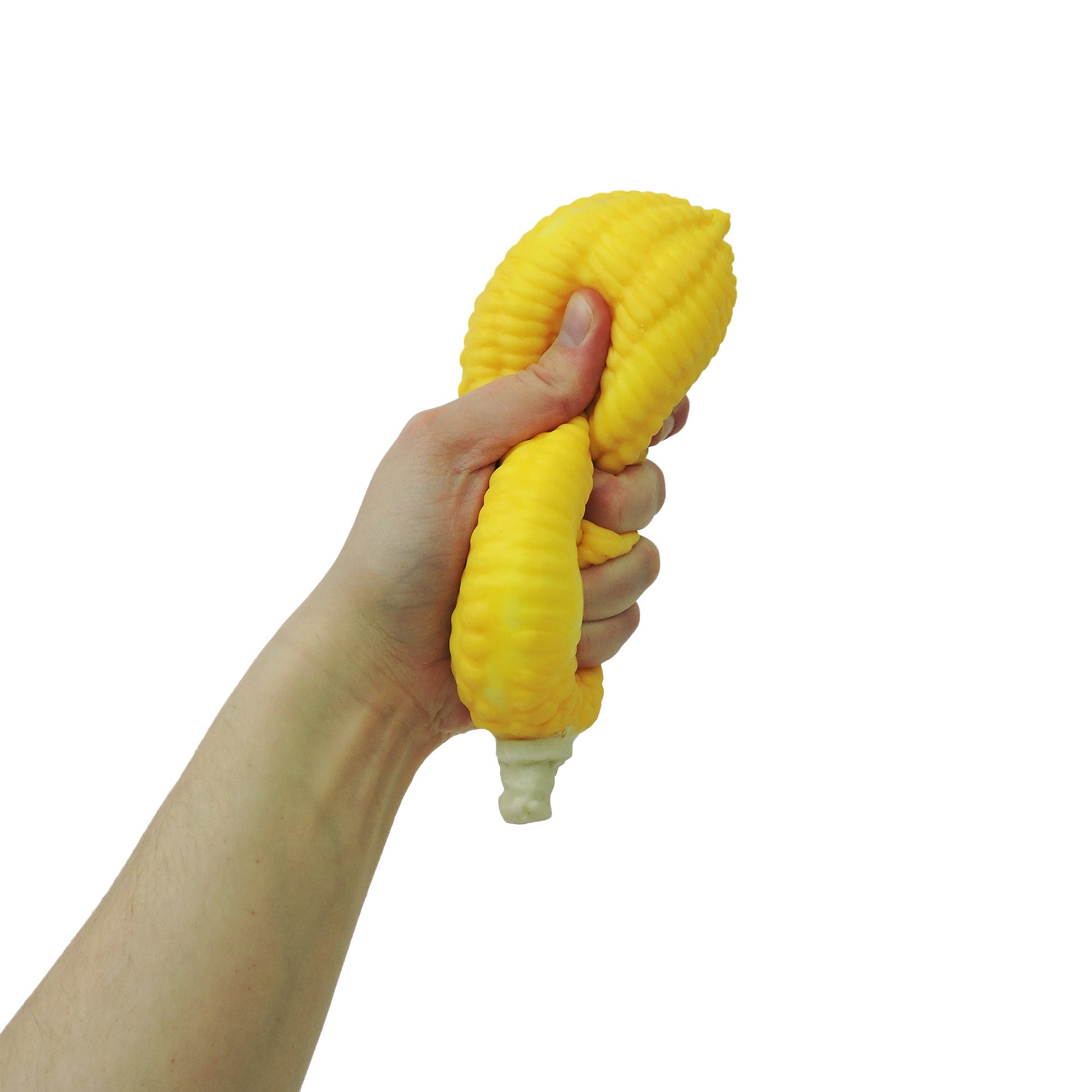 A hand squeezes the Toysmith Corn on the Cob fidget toy by Toysmith against a white background, visibly deforming the sensory toy under pressure.