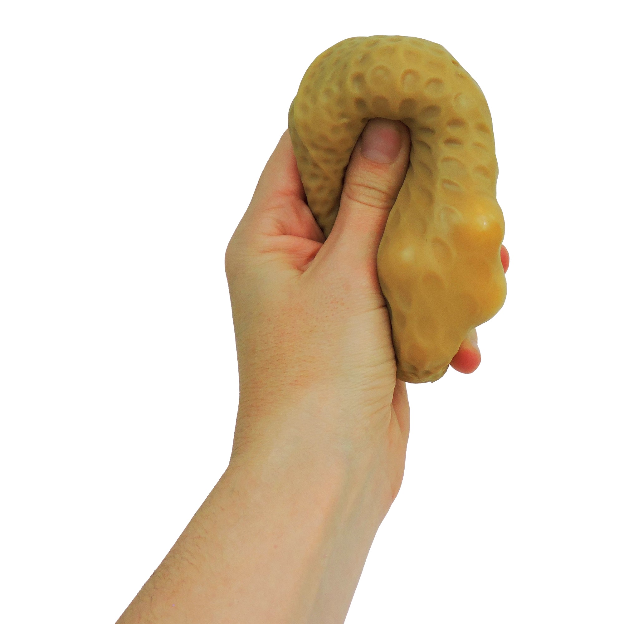 A hand squeezes the Toysmith Crunchy Nuts, a tan, textured, and flexible sensory toy by Toysmith, resembling a stress ball against a white background.