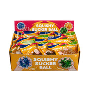A colorful Toysmith display box labeled "Toysmith Squishy Sucker Ball" holds multiple mesh-covered sensory balls in assorted colors, each individually packaged, with illustrations of hands squeezing the squishy balls on the box.