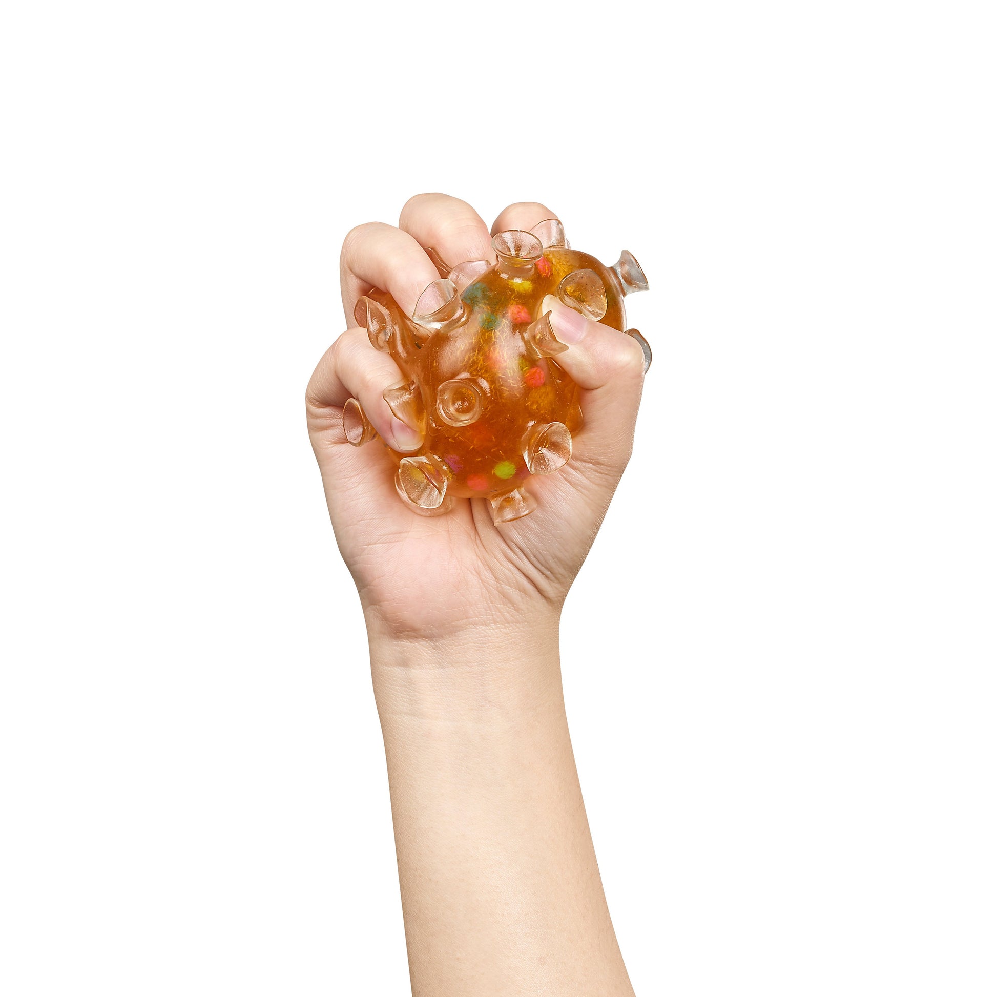 A hand squeezes the Toysmith Squishy Sucker Ball by Toysmith, a translucent orange sensory toy filled with colorful beads, creating a fun tactile experience against a white background.