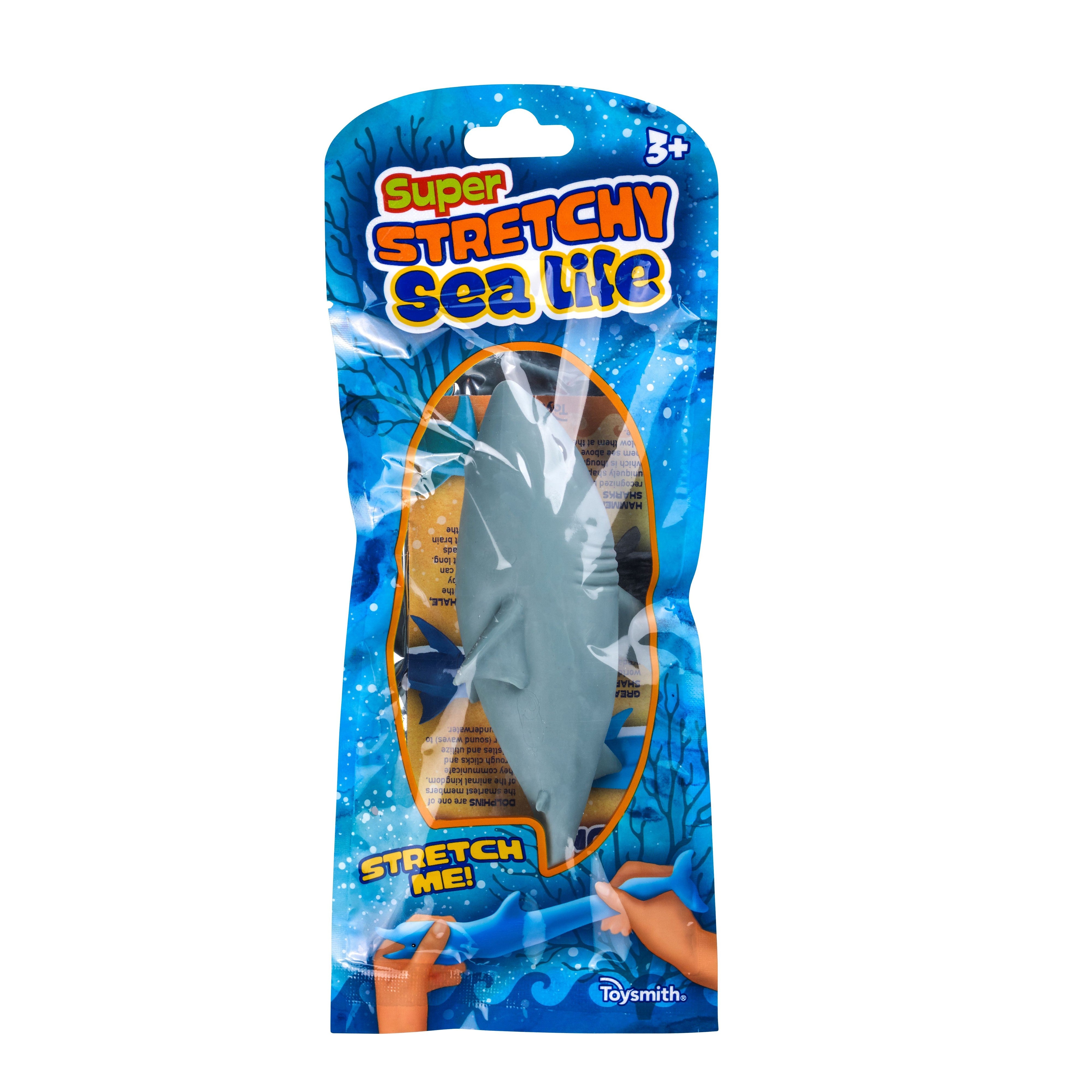 The Toysmith Super Stretchy Sand Filled Sea Life is a blue plastic shark sensory toy for ages 3+, in sealed packaging with ocean graphics, sea creatures, and “Stretch Me!” text beside an illustration of a hand stretching the toy.