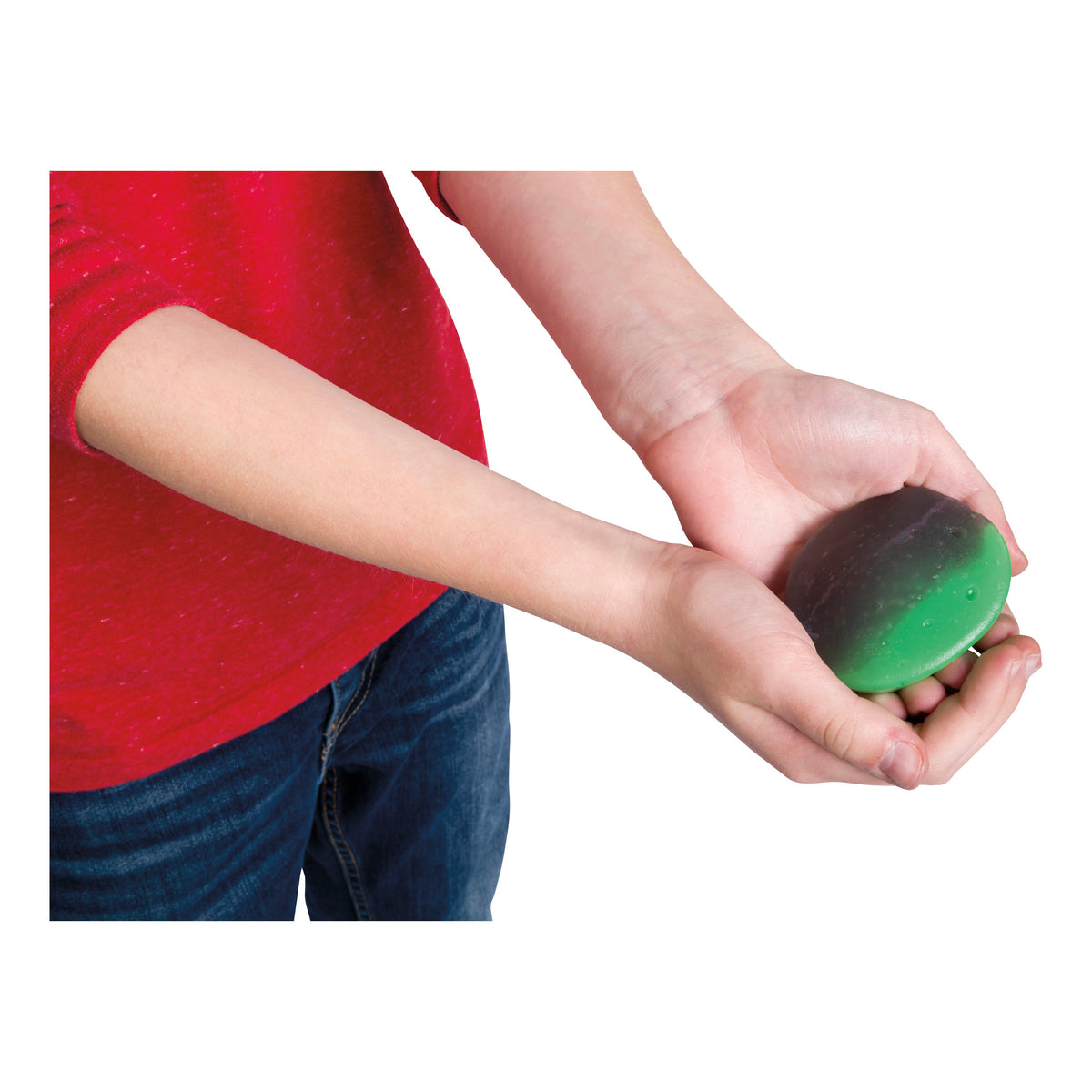 A person in a red shirt and blue jeans holds Glow-Tec's Mood Mudd Changing Color Dough, green and black in color, with both hands against a white background.